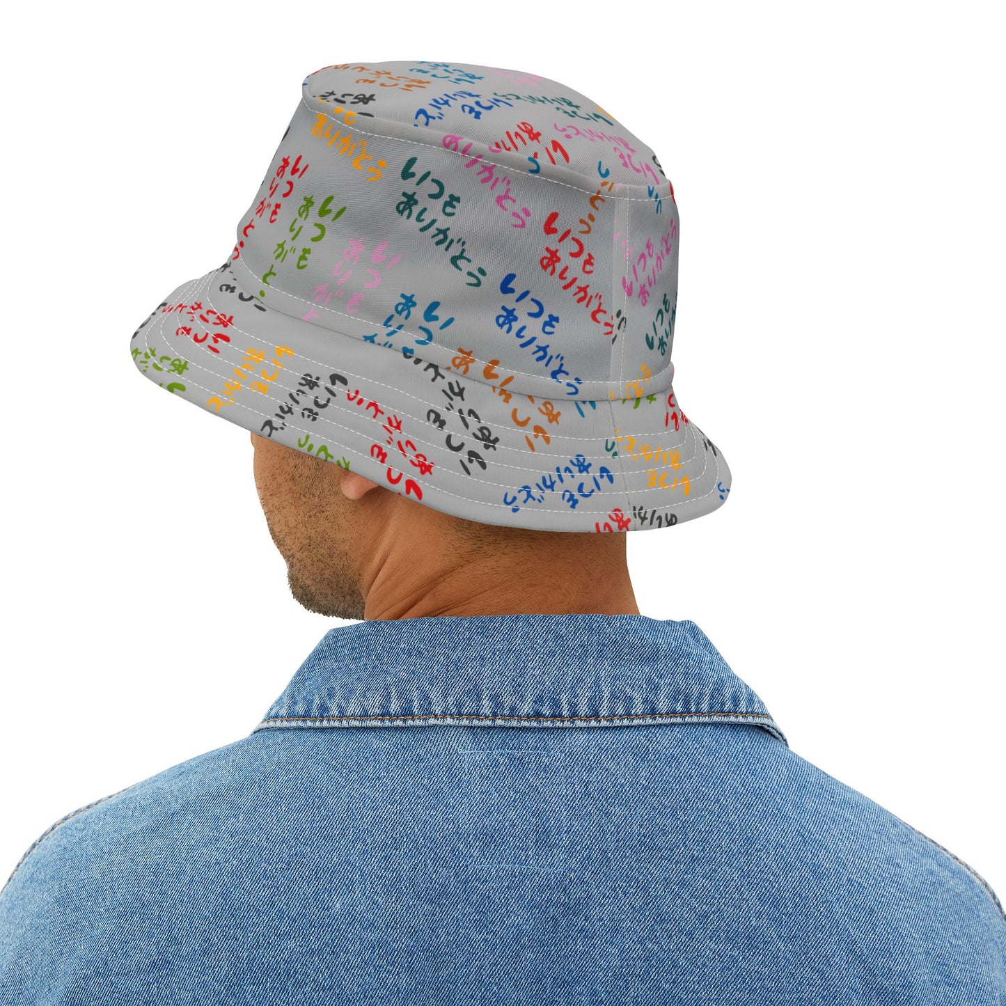 Person wearing a colorful bucket hat with text on a white background