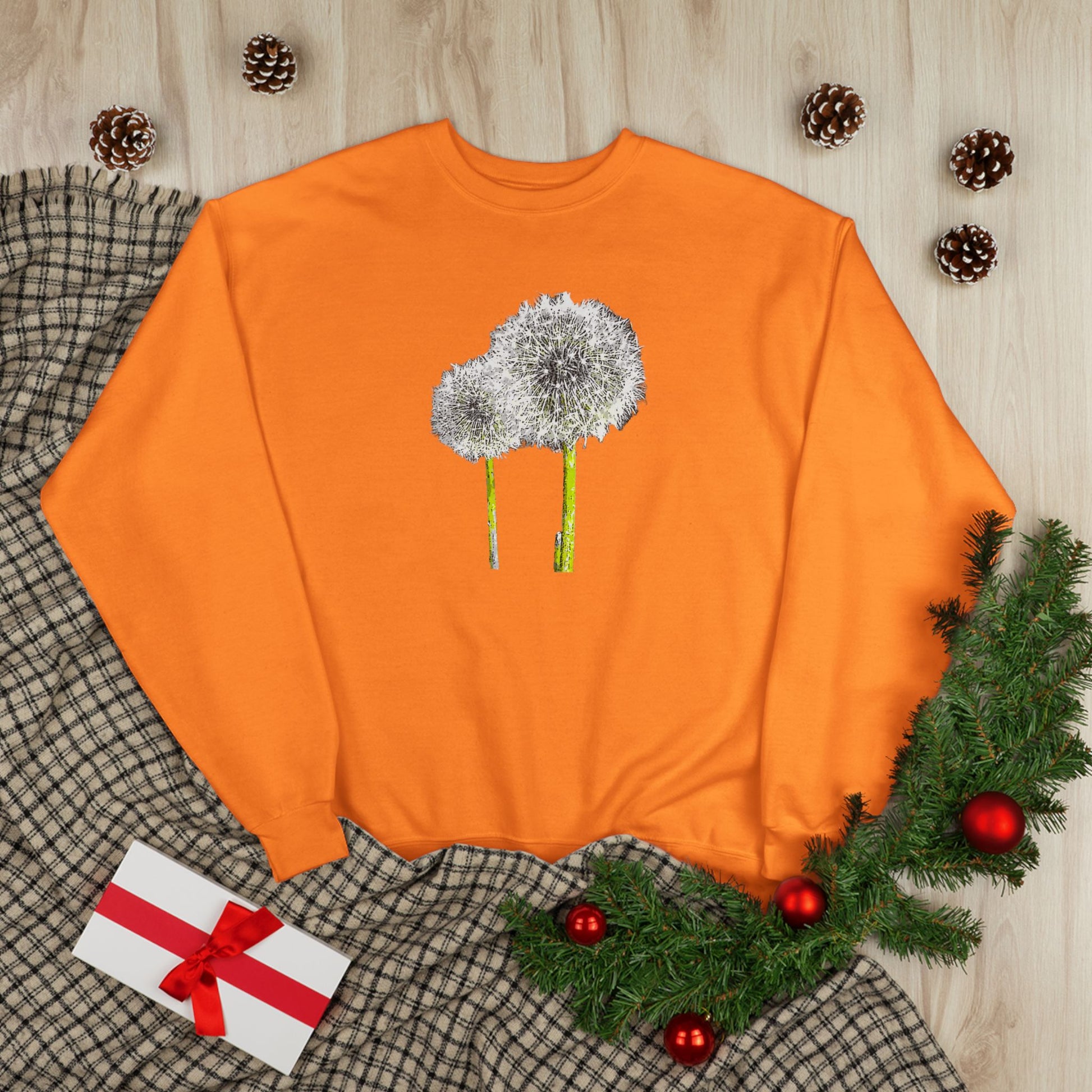 Orange Tantrum Media Dandelion Unisex Sweatshirt with white dandelion print, holiday decor flat lay