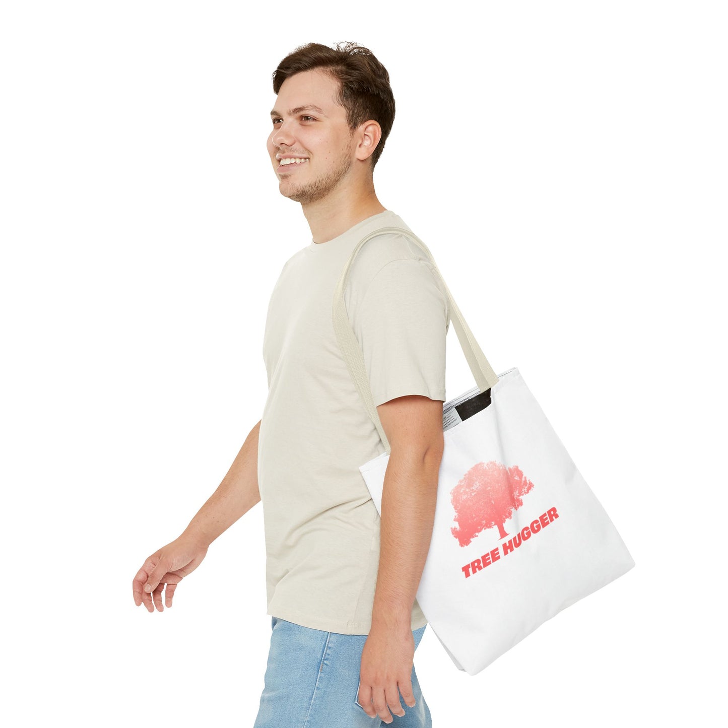 Man standing carrying Tree Hugger Tote Bag with red tree graphic