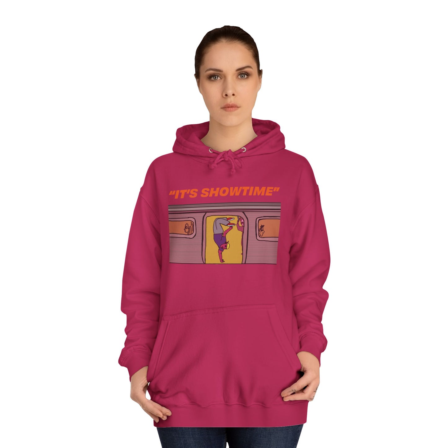Female model wearing dark pink It’s Showtime Hoodie with subway performer artwork on front.