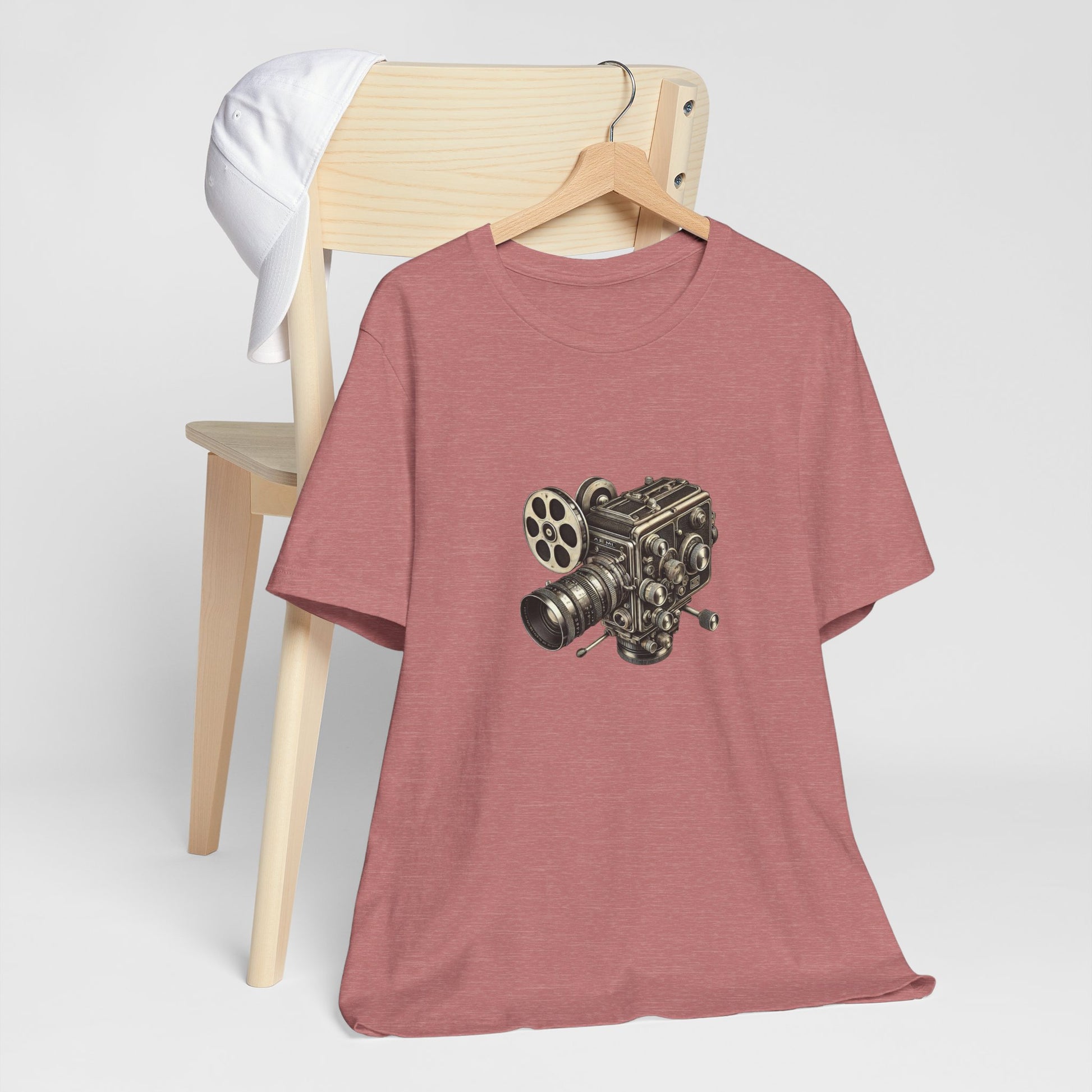 Rust red t-shirt with vintage 16mm camera design draped over chair