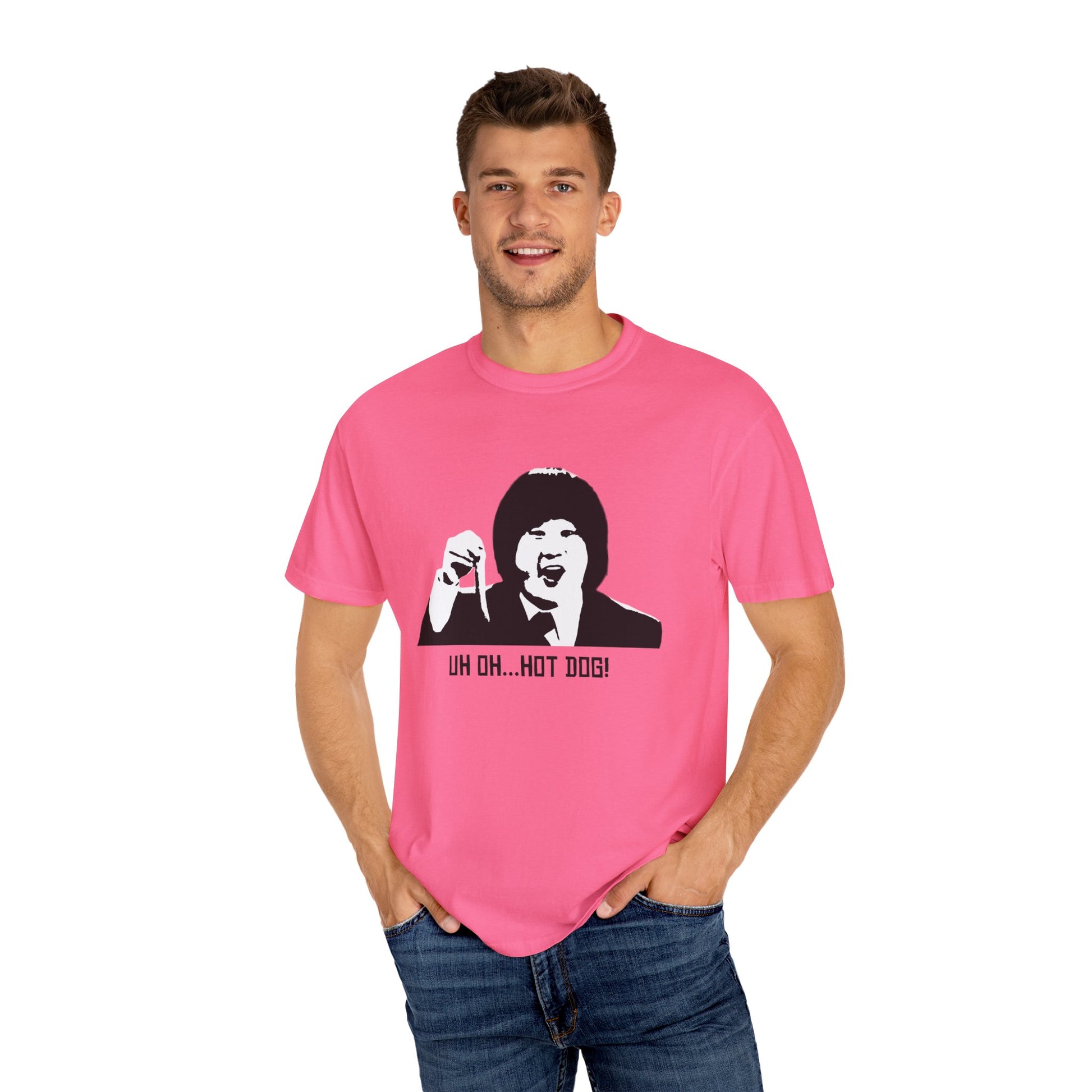 Man modeling pink Uh Oh Hot Dog T-shirt, smiling with hands in pockets.