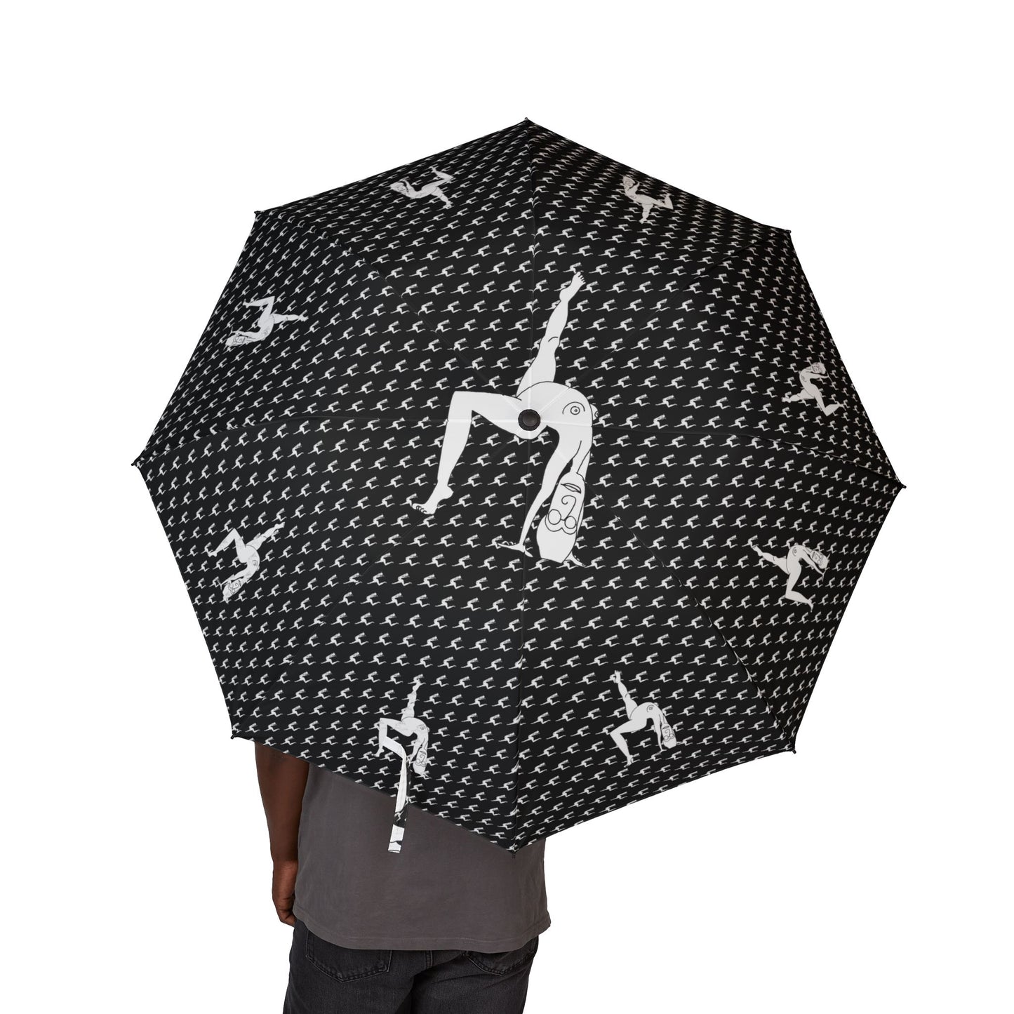 Person holding a black Elastika Umbrella with white hand-drawn dancing figures
