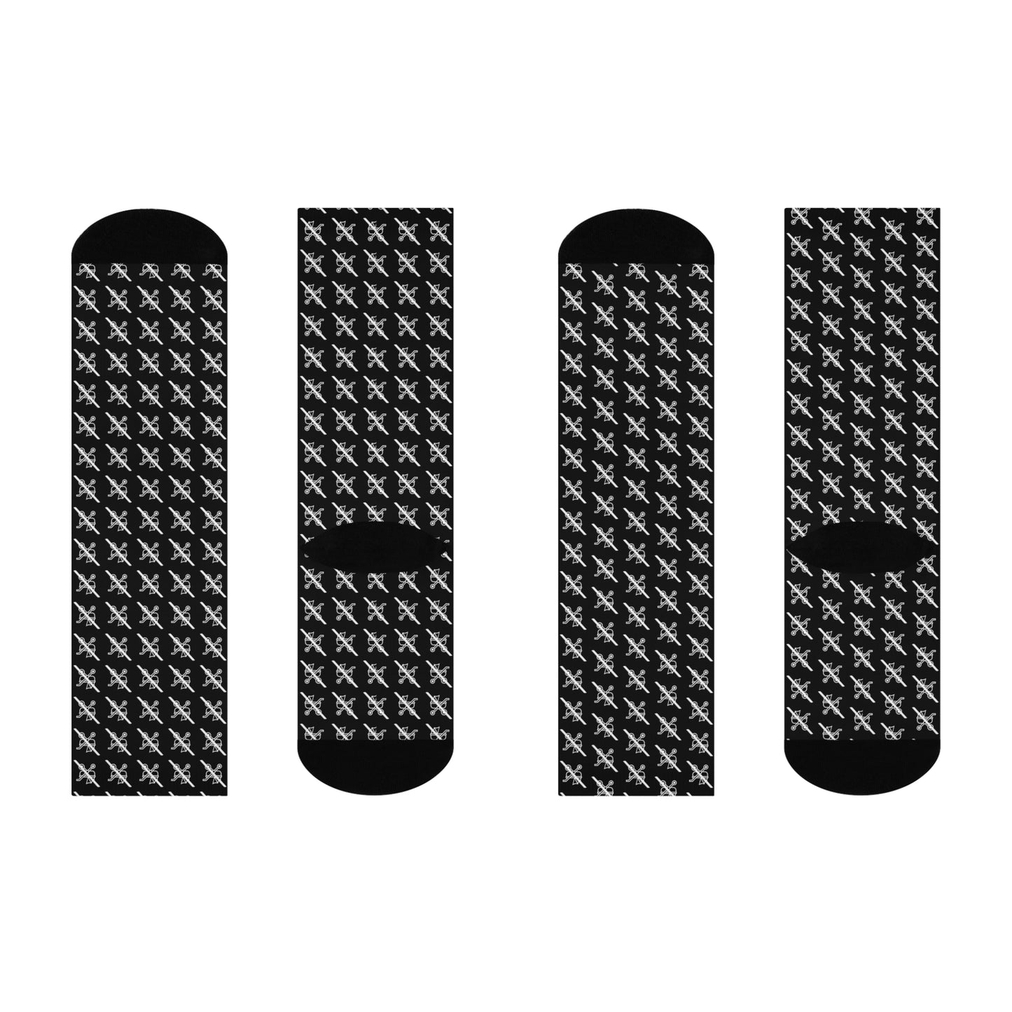 Four black socks with white pattern on a white background