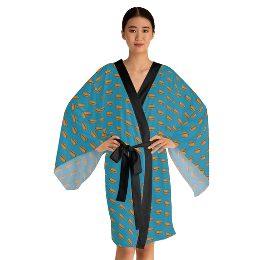 A stylish satin kimono robe with a vibrant blue background featuring a chopped cheese sandwich print, complemented by a sleek black trim and adjustable waist tie.