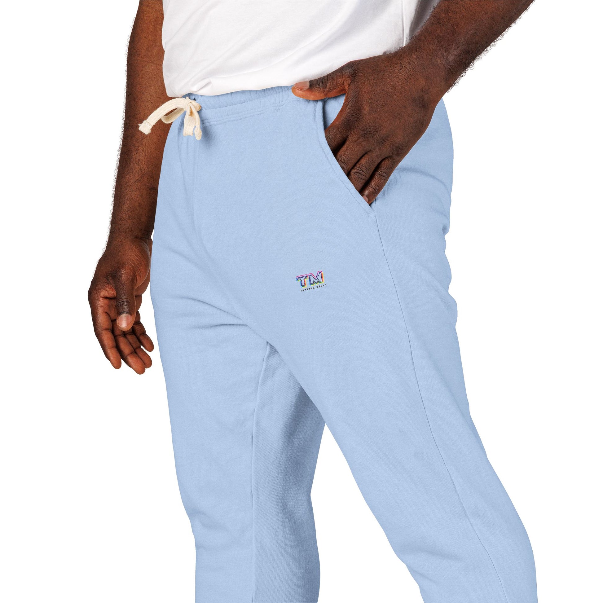 Close-up of blue Tantrum Media Sweatpants with drawstring waist and logo