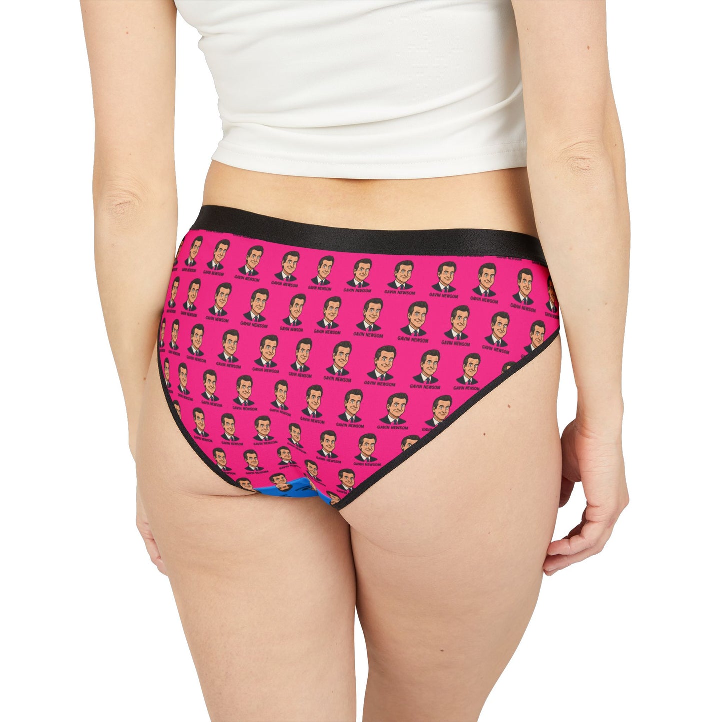 Model wearing Gavin Newsom-themed panties showing the full pink back panel with repeating graphic faces and a high-leg cut.