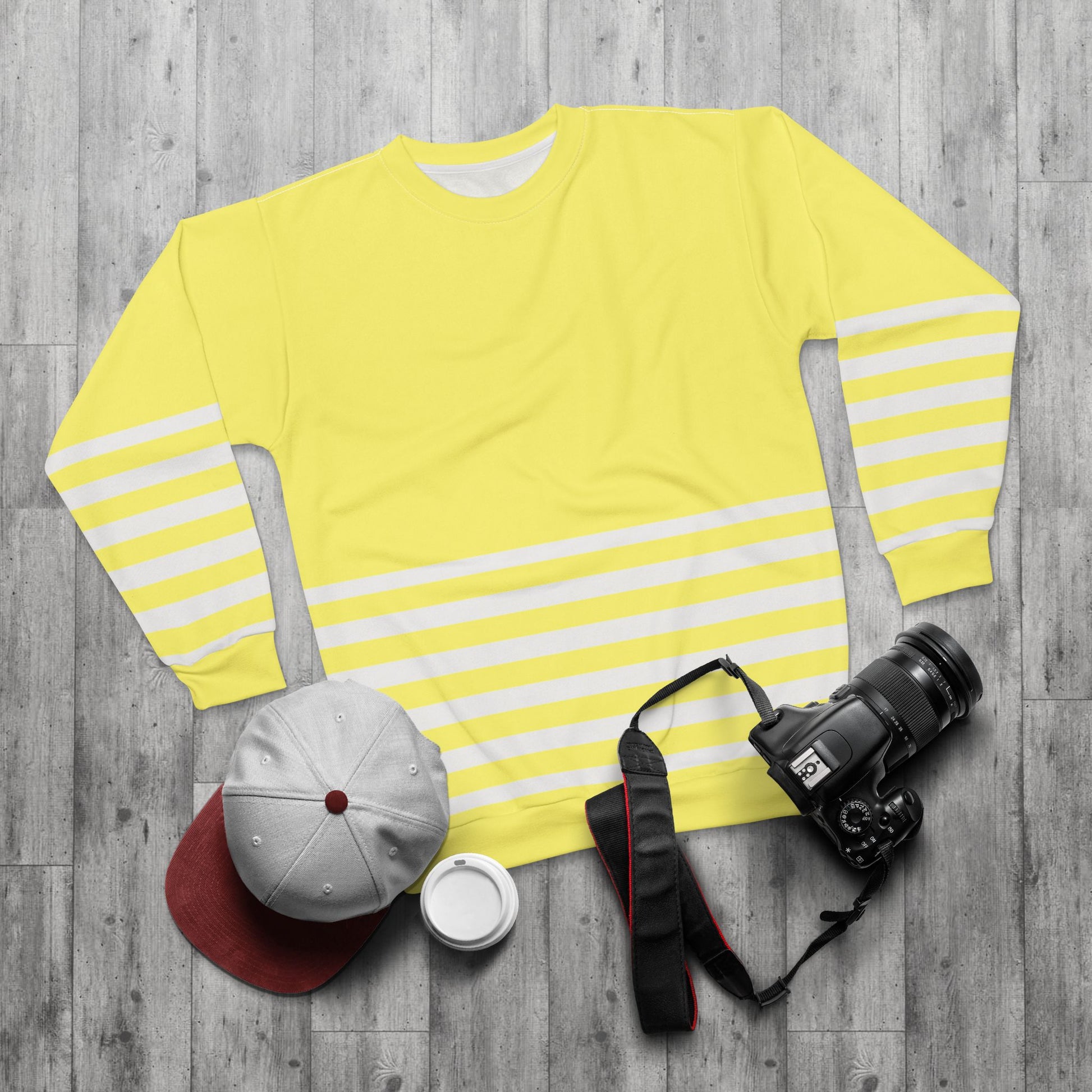Lifestyle flat lay yellow striped sweatshirt with cap and accessories
