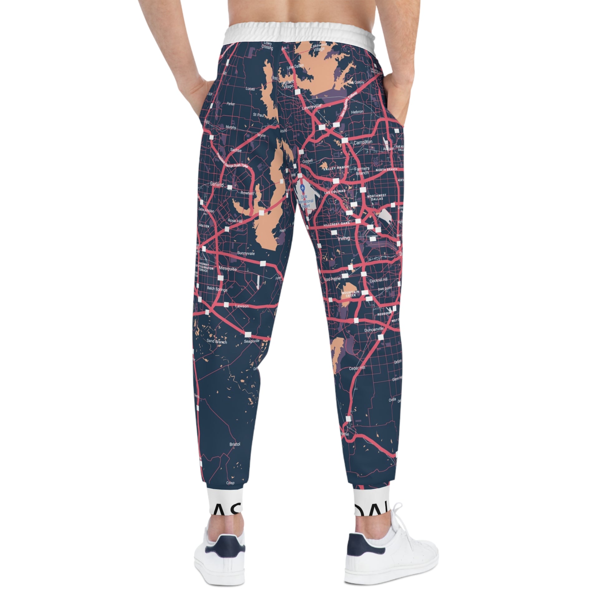 Map-patterned jogger pants worn by a person on a white background