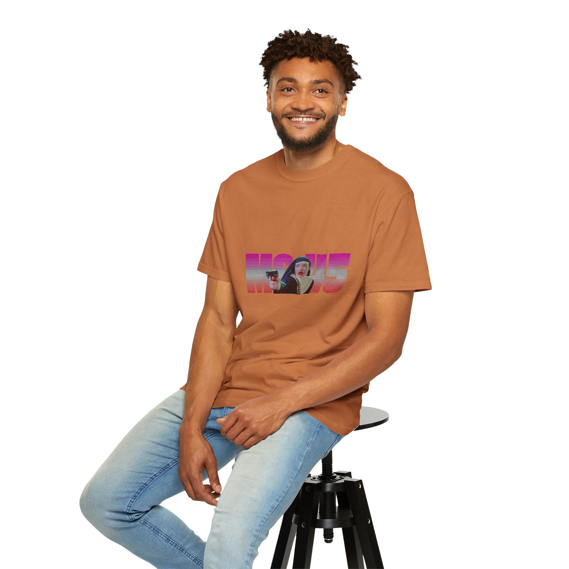 Man wearing brown Ms.45 T-Shirt seated on stool smiling