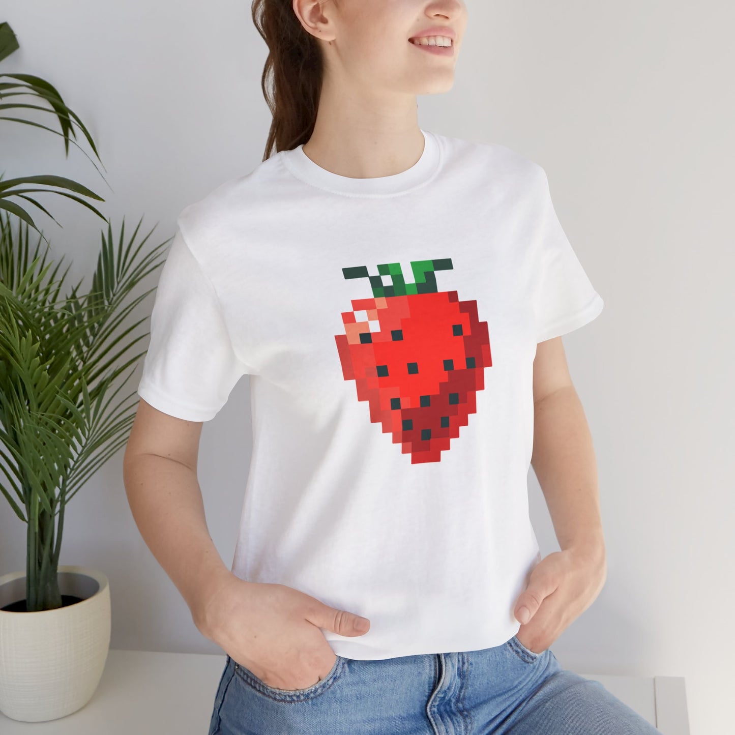 Male model wearing retro pixel strawberry graphic gaming shirt