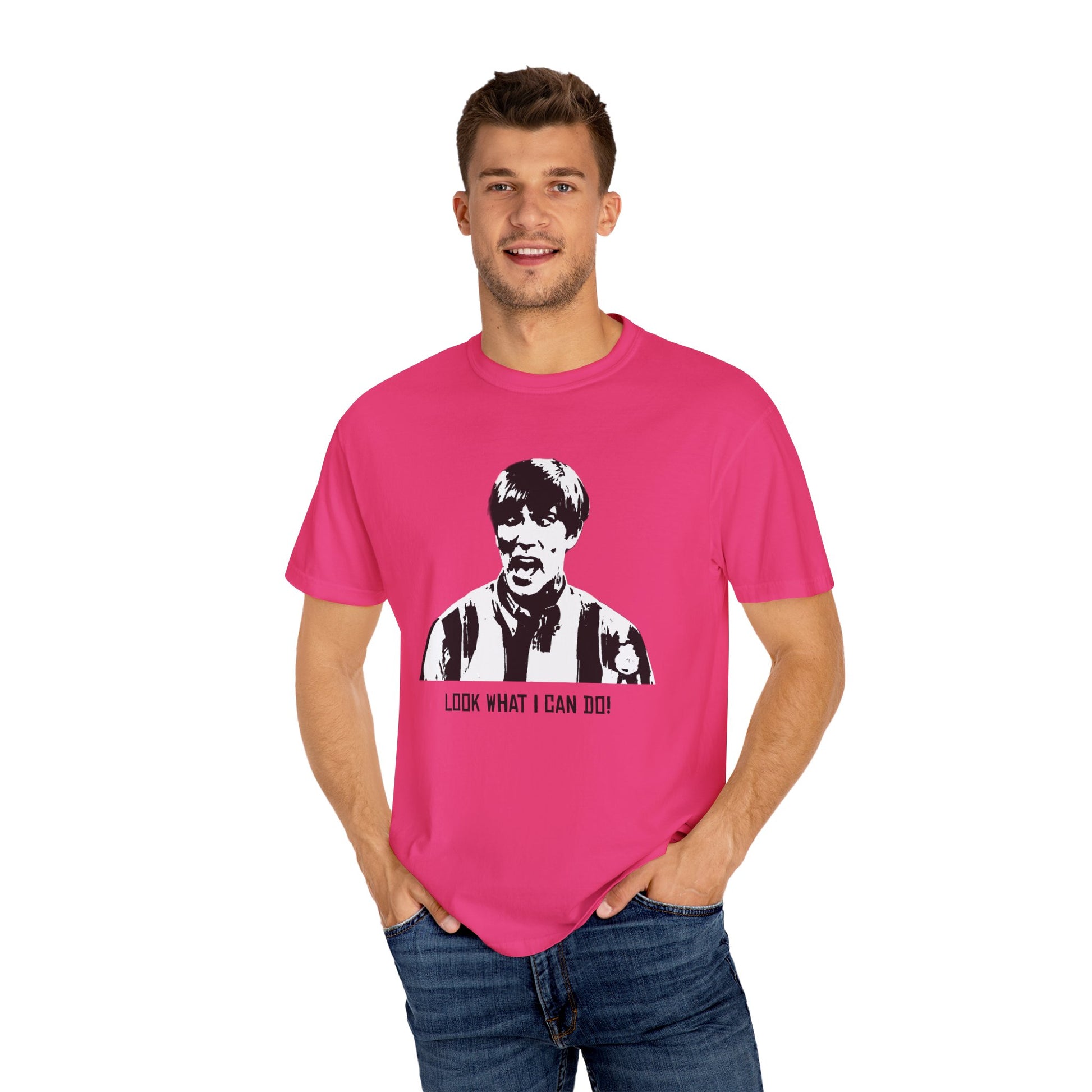 Man modeling hot pink Stuart MadTV T-shirt, hands in pockets and smiling.
