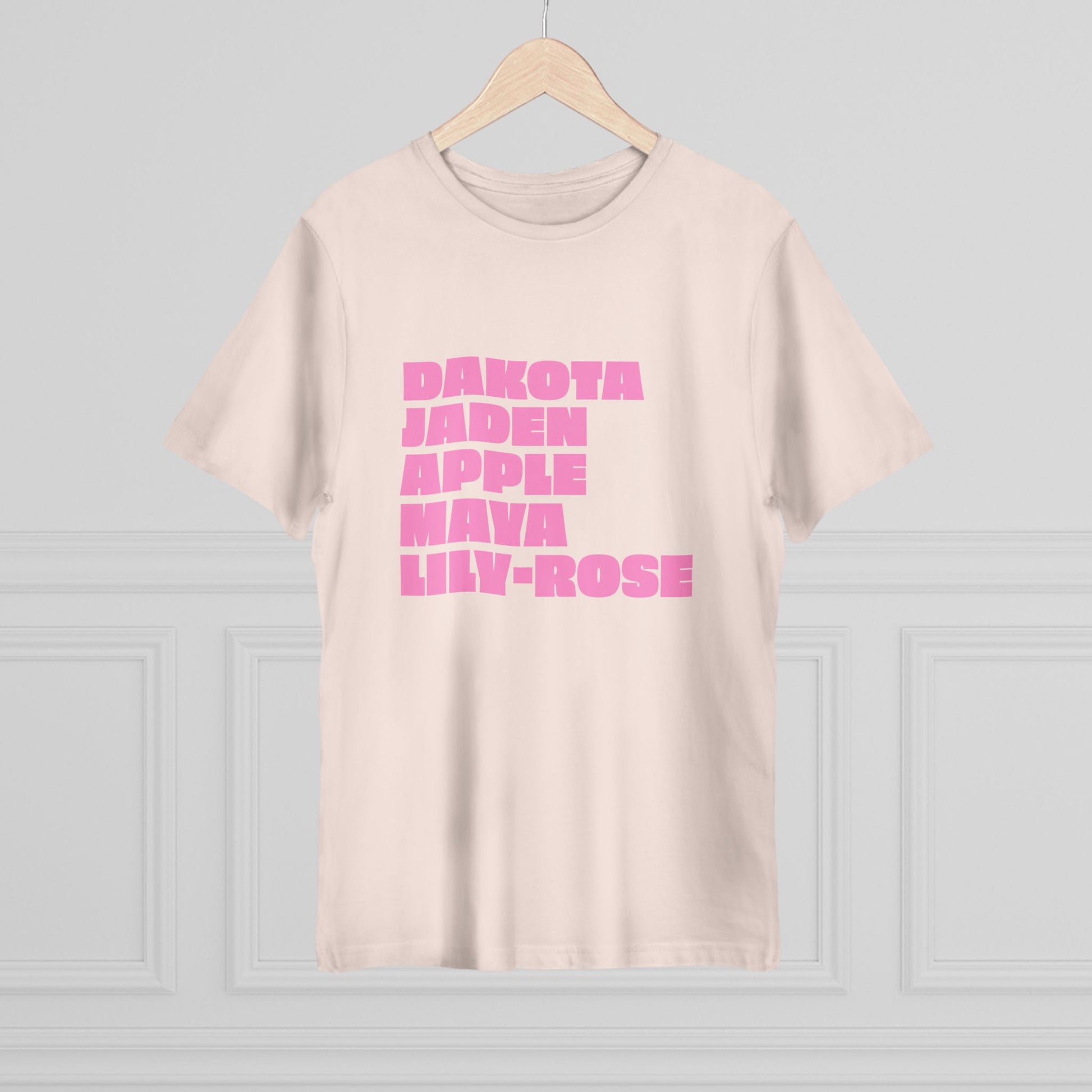 Beige Nepo Babies List T-Shirt with pink lettering on hanger