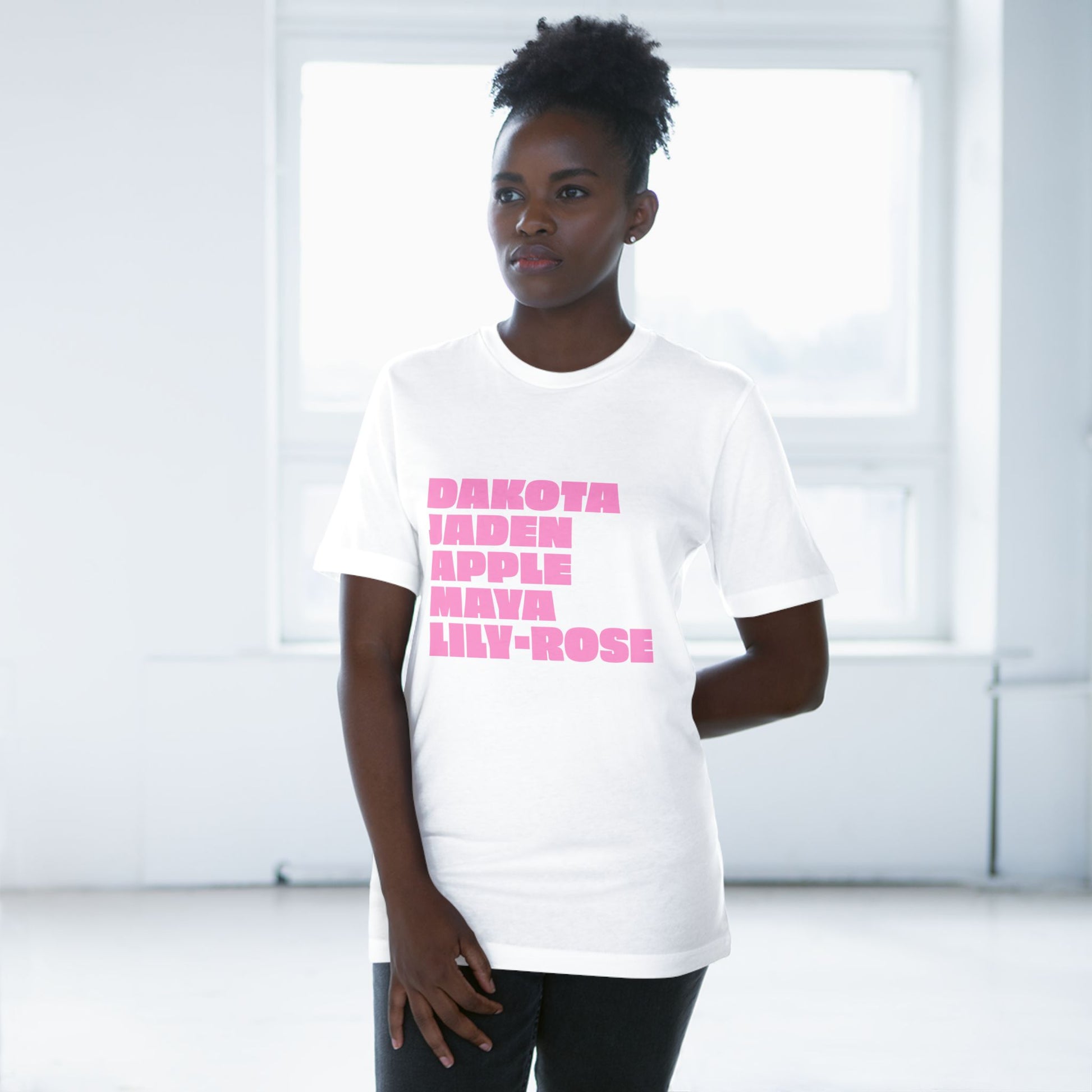 White Nepo Babies List T-Shirt with pink lettering worn by female model