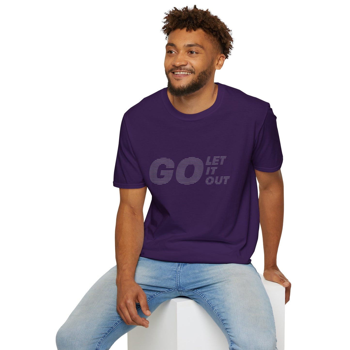 Man sitting wearing purple Oasis Go Let It Out stencil t-shirt, smiling.
