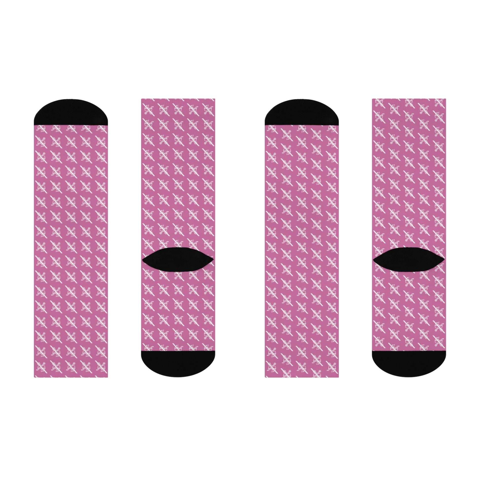 Flat lay of four  pink Proudly Childless crew socks with black heel and toe shown from different angles