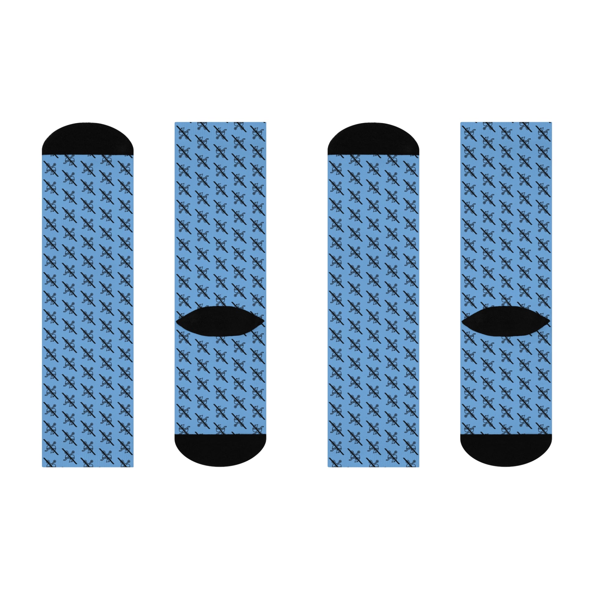 Flat lay of four  blue Proudly Childless crew socks with black heel and toe shown from different angles