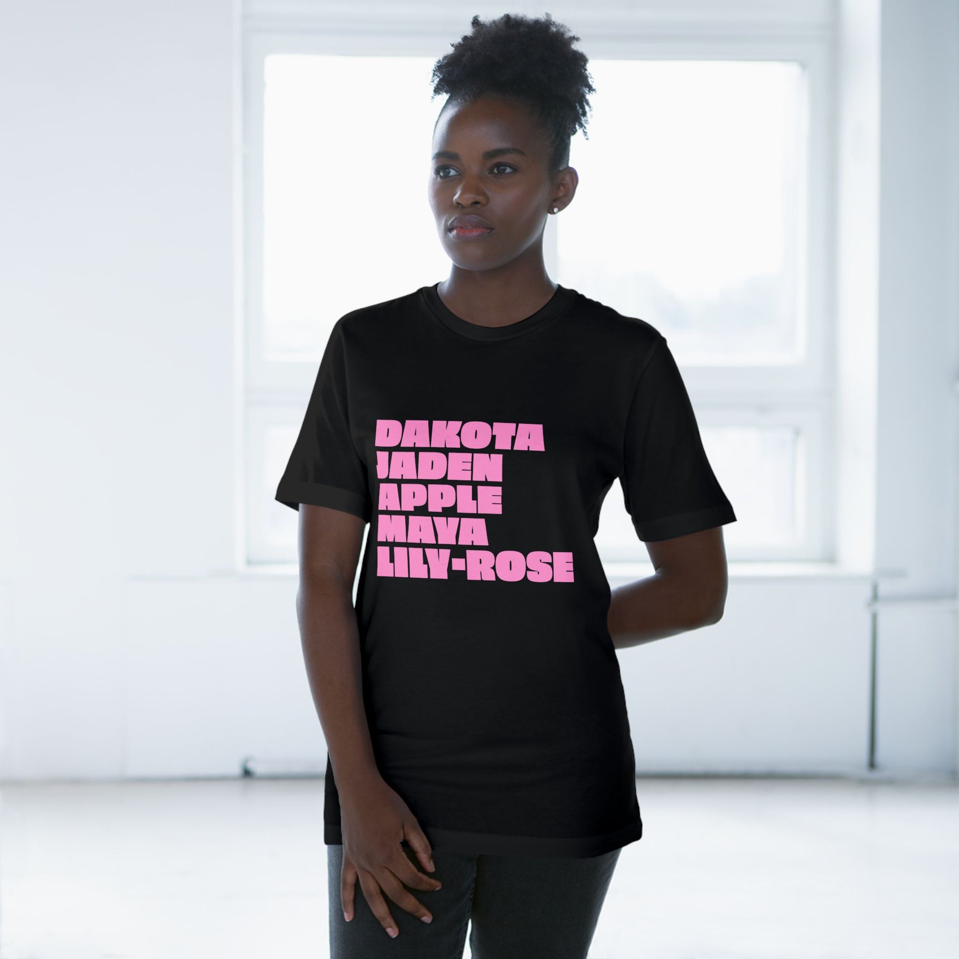 Black Nepo Babies List T-Shirt with pink lettering worn by female model