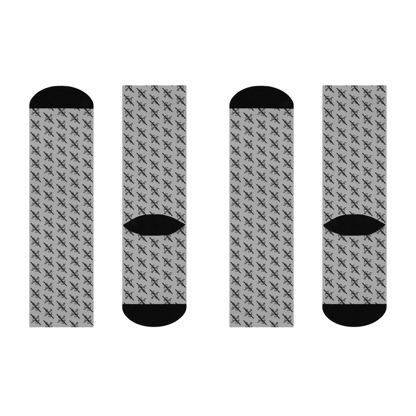 Flat lay of four  grey Proudly Childless crew socks with black heel and toe shown from different angles