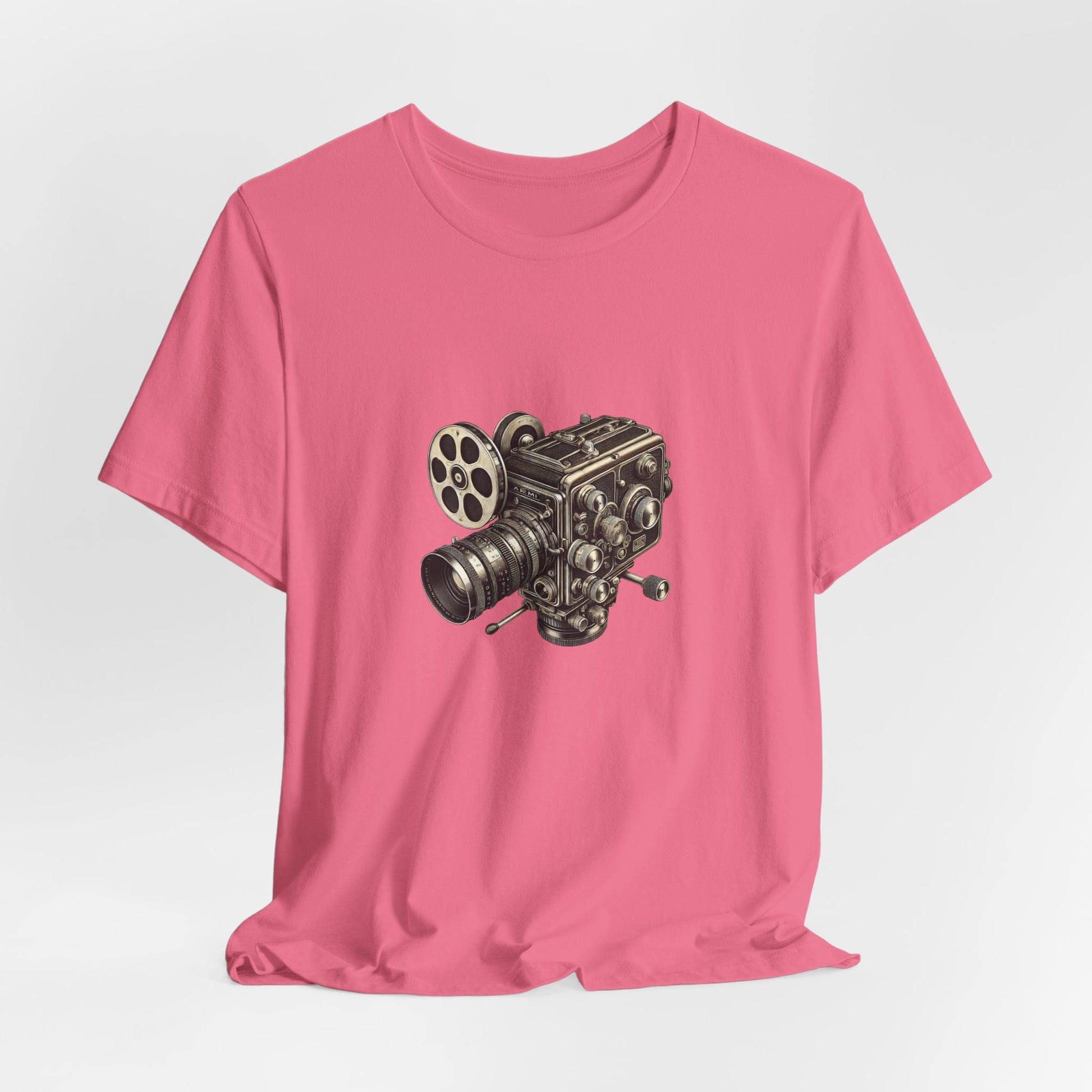 Bright pink t-shirt with vintage 16mm camera design laid flat