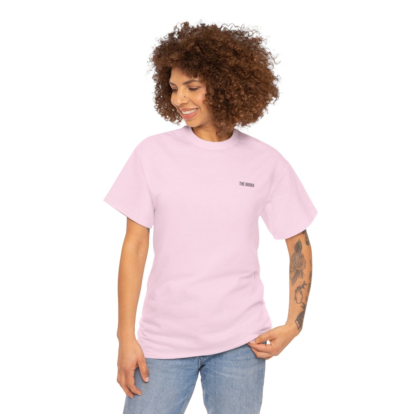 Female model wearing The Bronx T-Shirt in light pink, front view with smile