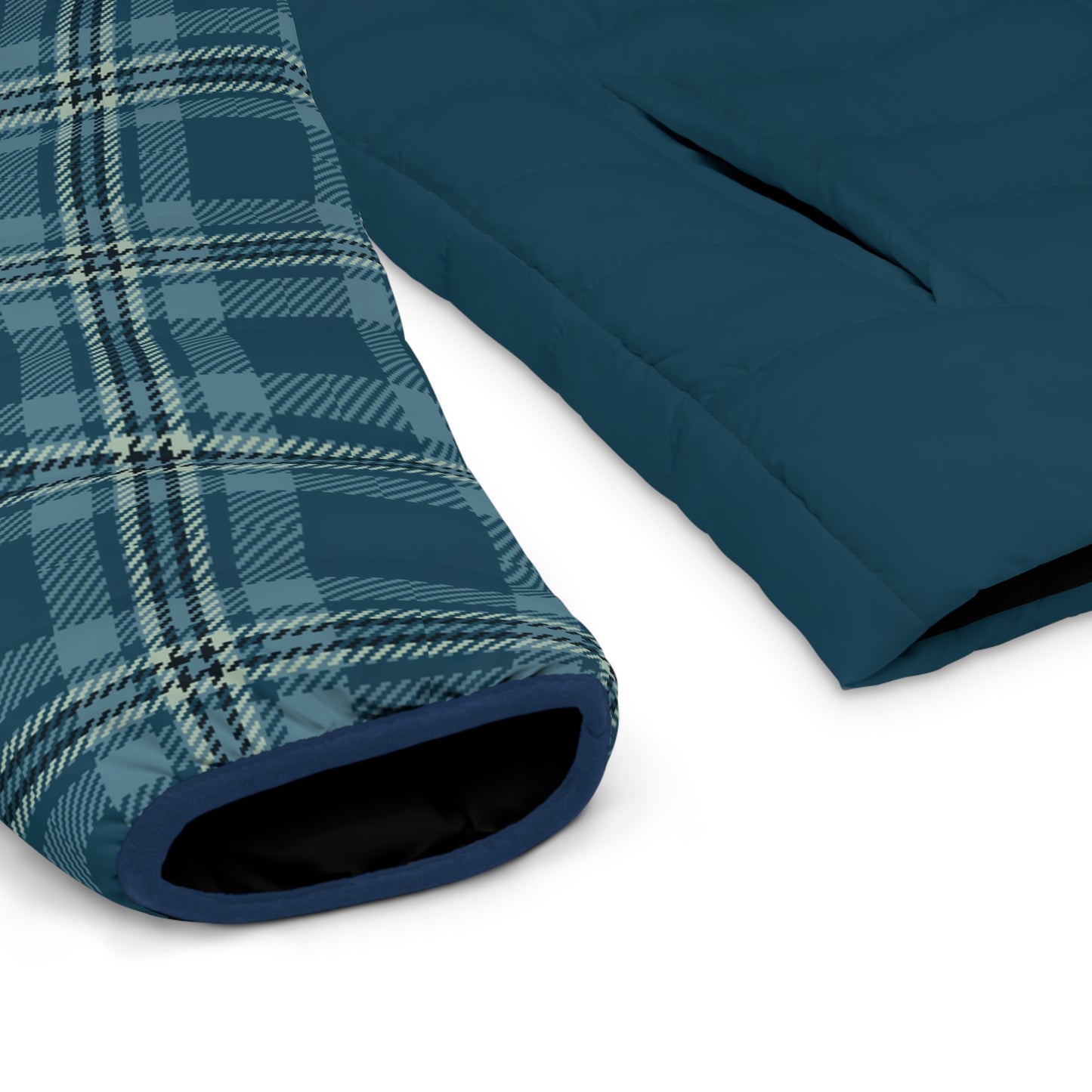 Close-up of blue plaid fabric and plain blue fabric on a white background