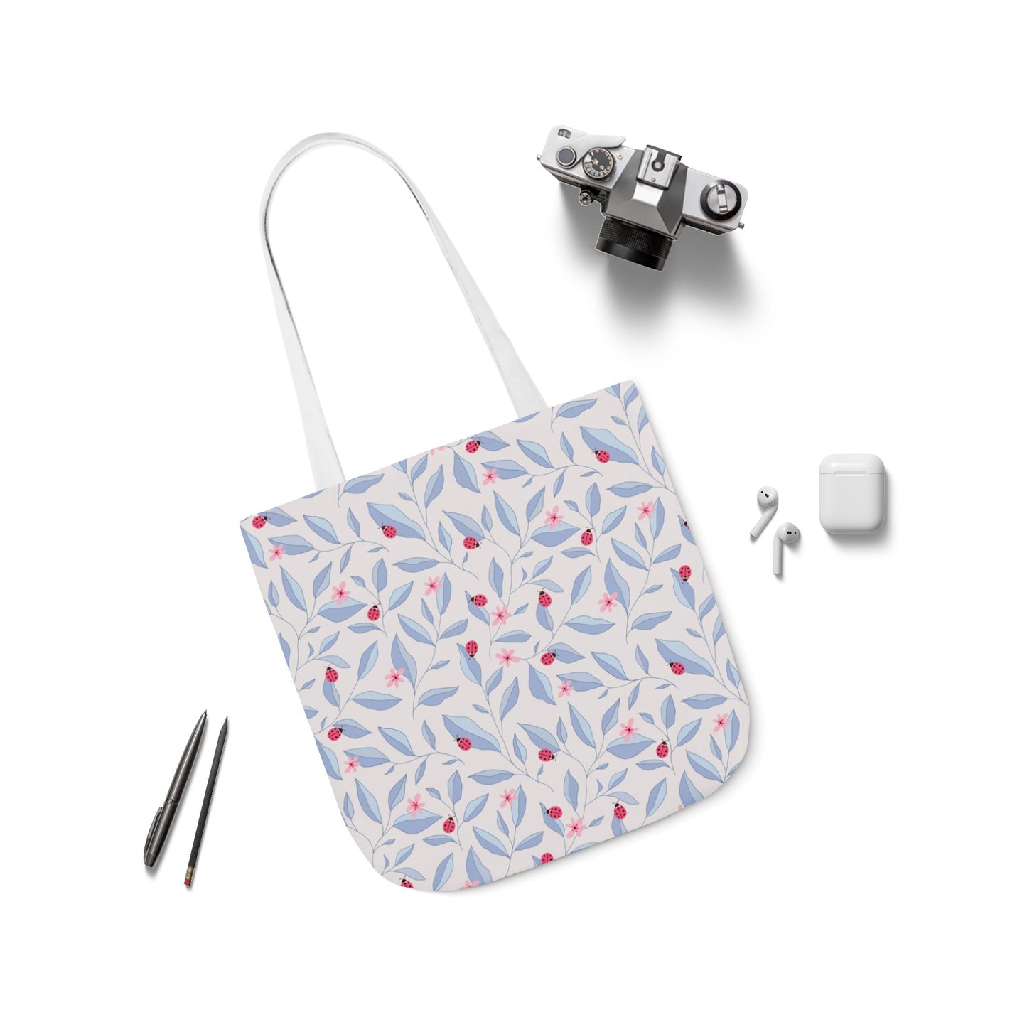 Lady Bug Garden Tote Bag with accessories laid around it.