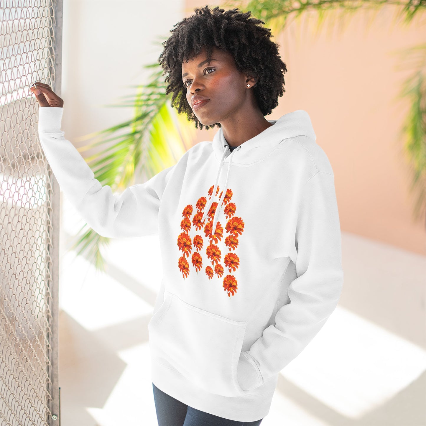 Woman wearing white Zinnia Hoodie posing near window