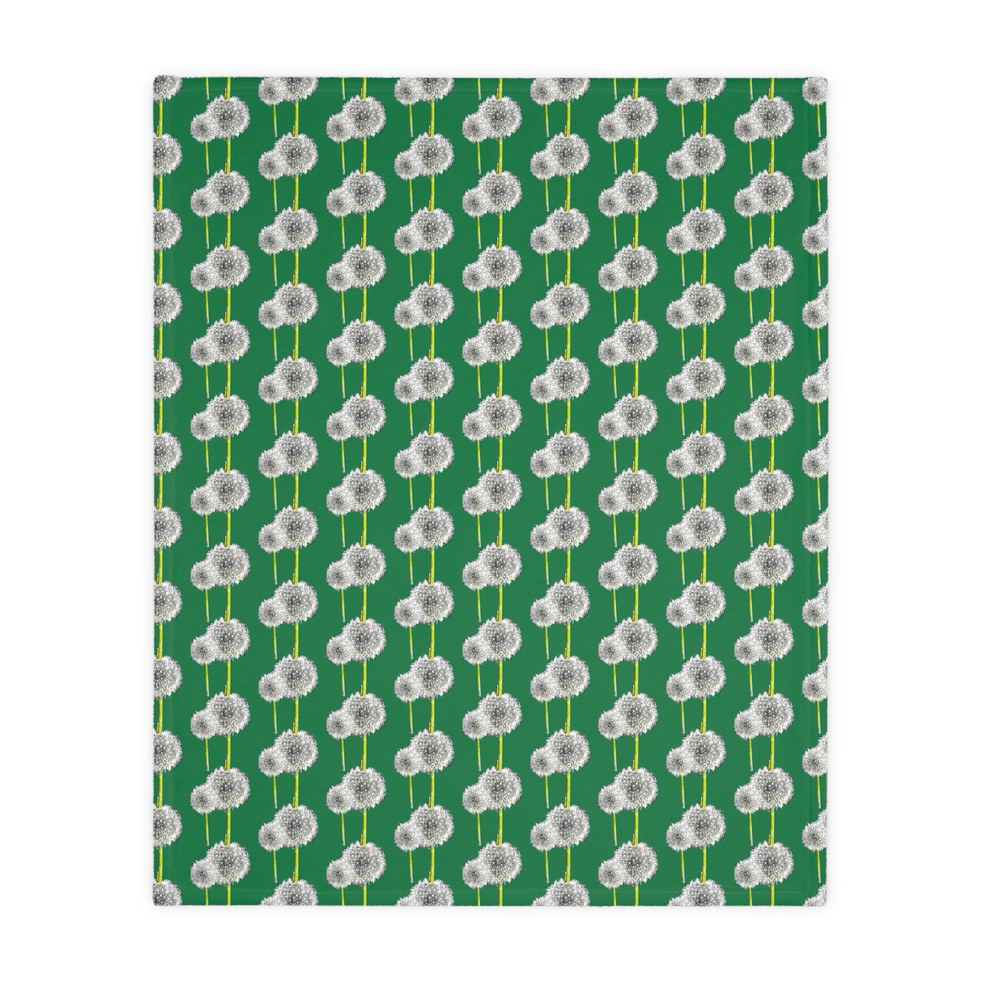 Angled flat view of green blanket with white dandelion print
