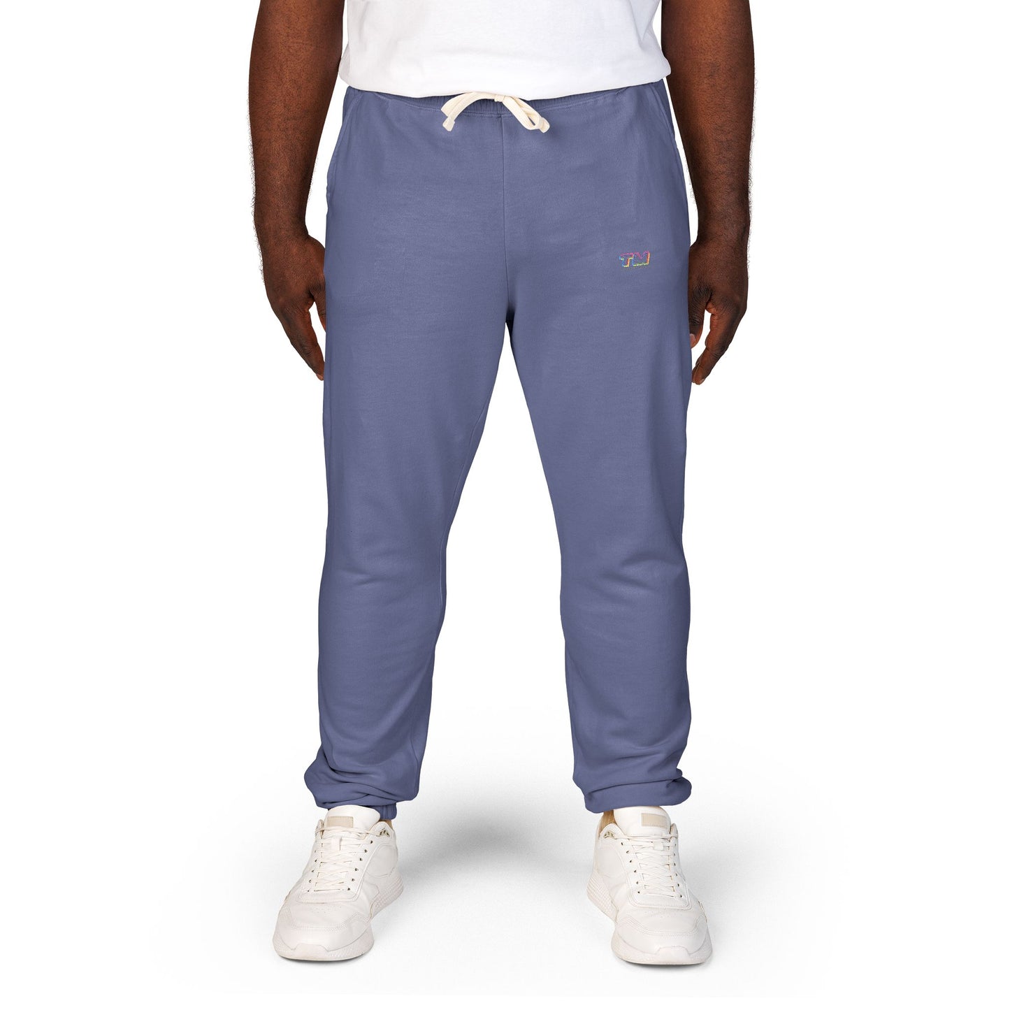 Person wearing blue jogger pants with Tantrum Media logo on a white background