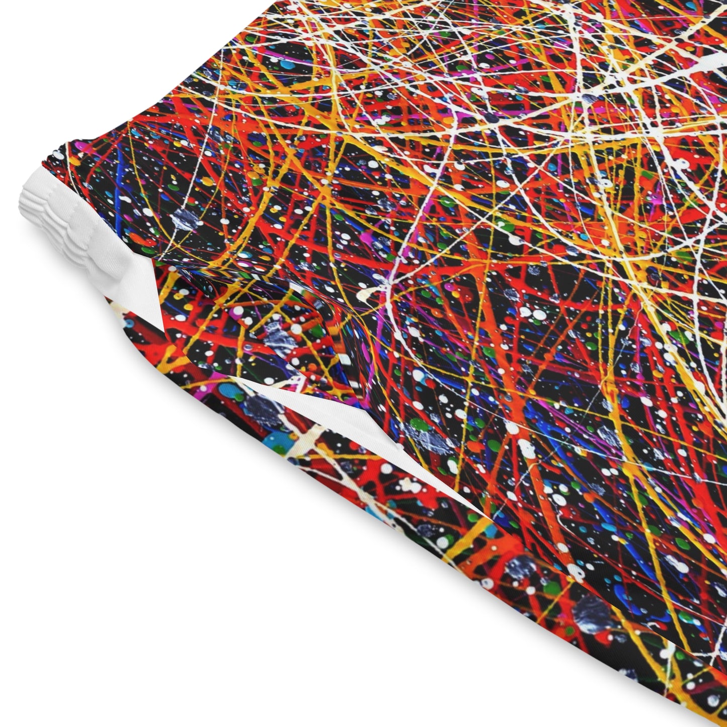 Close up of Neon Chaos Shorts fabric showing neon splatter detail and lightweight material