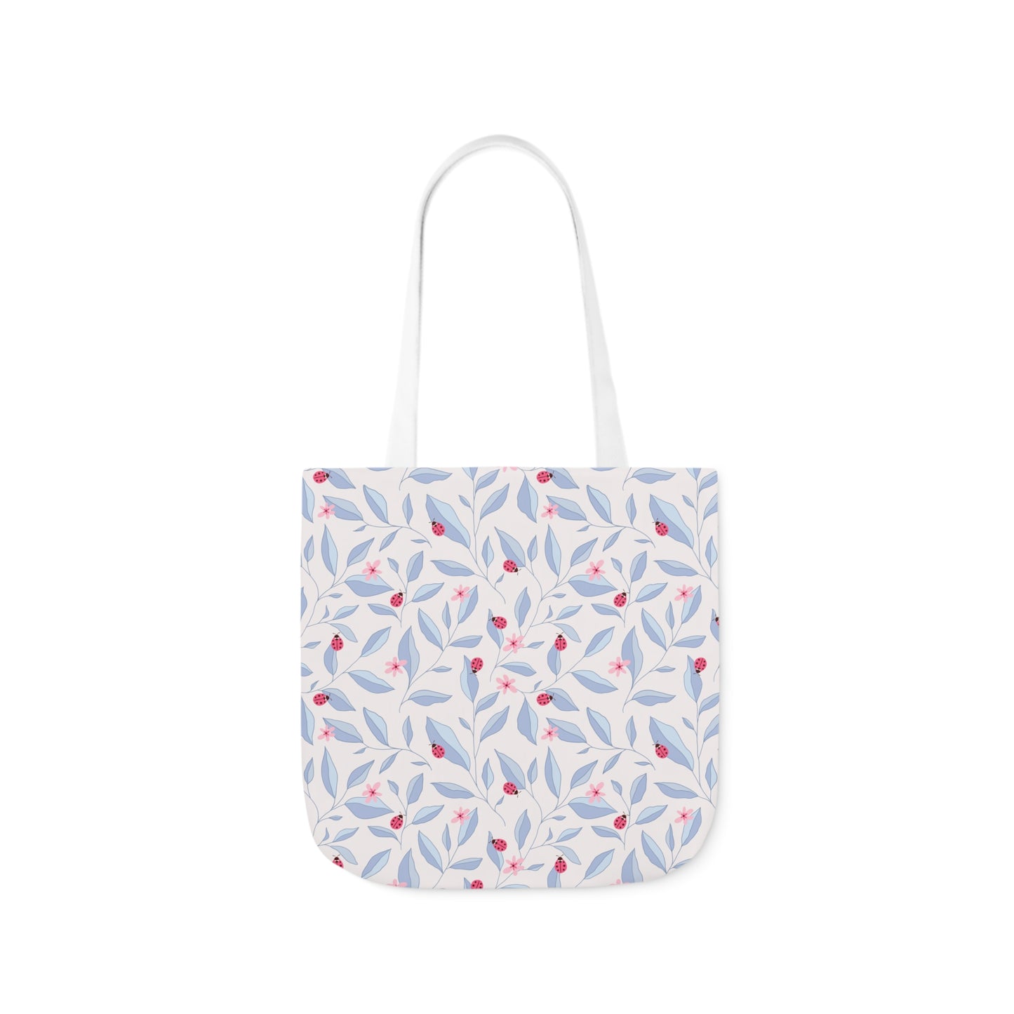 White tote bag featuring a soft blue and pink leafy pattern with small ladybugs