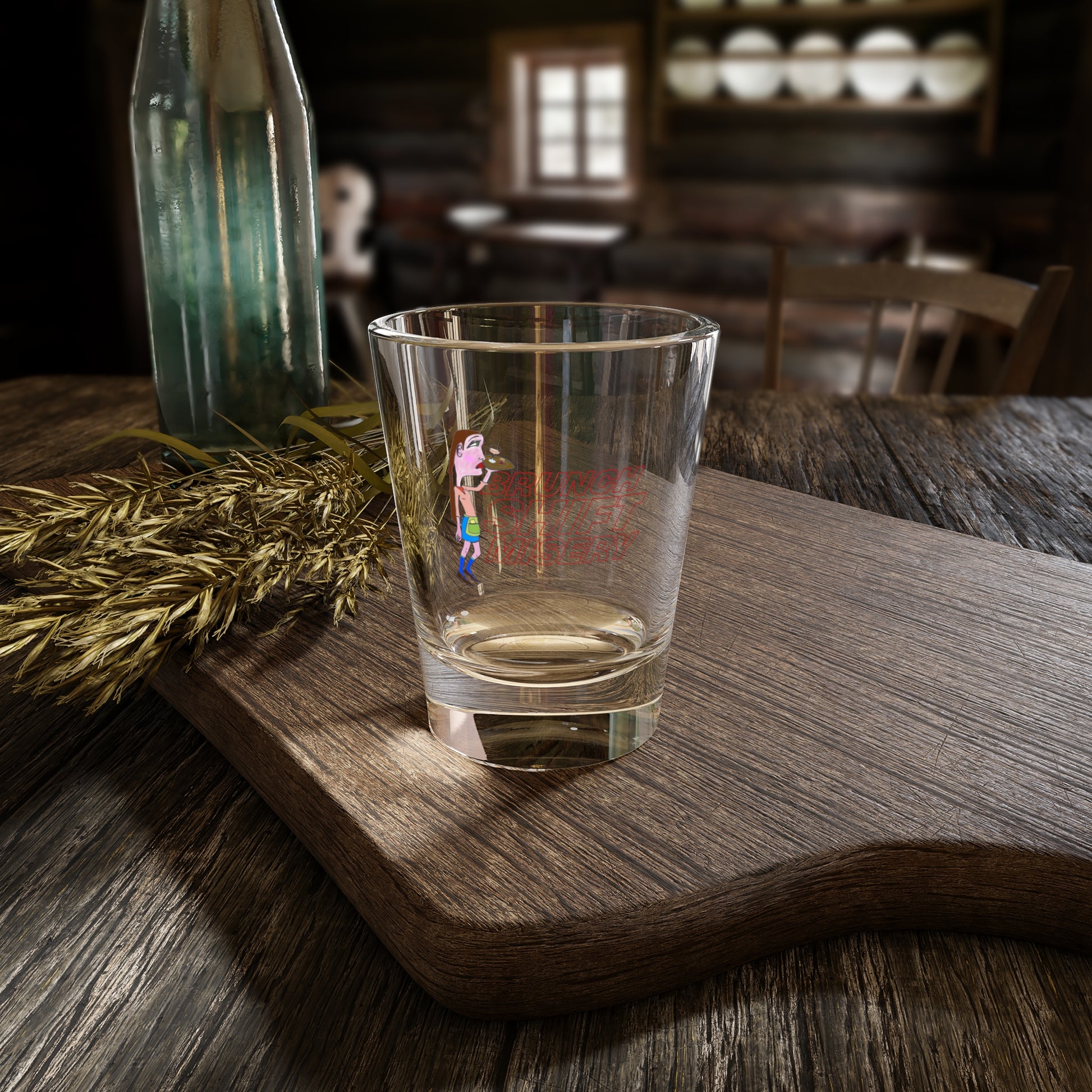 Clear glass with a printed design on a wooden surface in a rustic setting