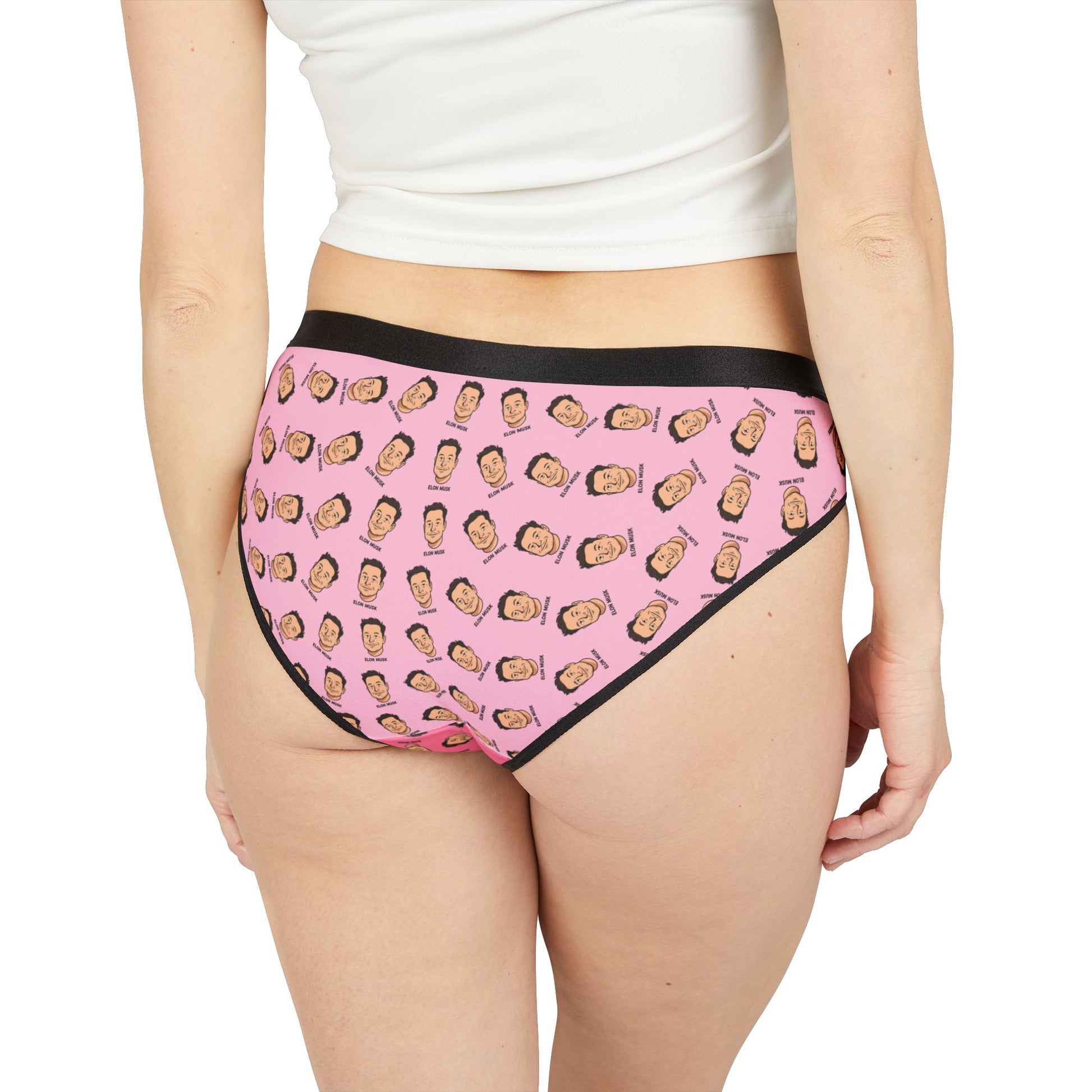 Back view of a woman wearing Elon Musk Panties, featuring full-coverage print of cartoon Elon faces on pink background.