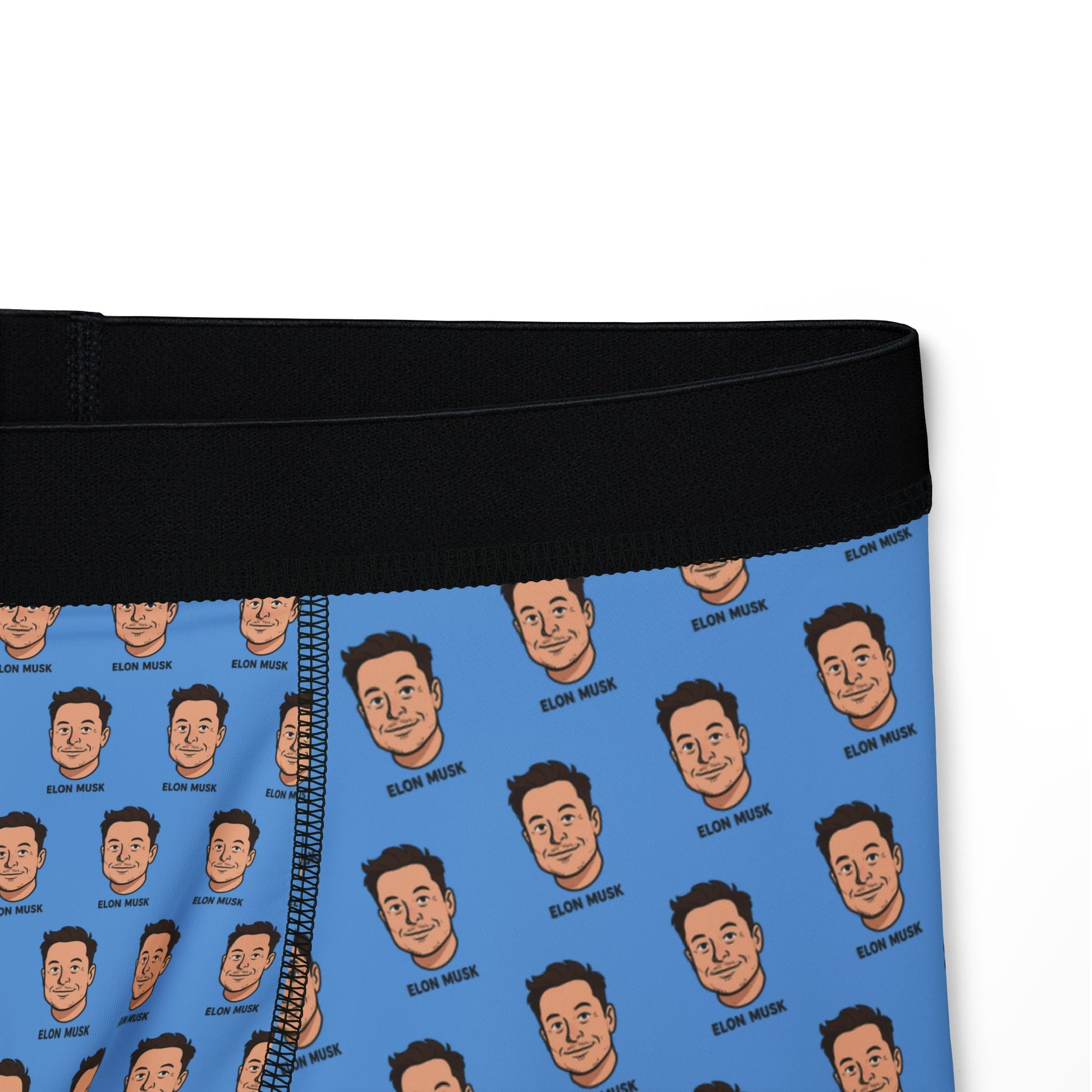 Close-up of waistband and printed Elon faces on blue fabric, showing texture and detail.