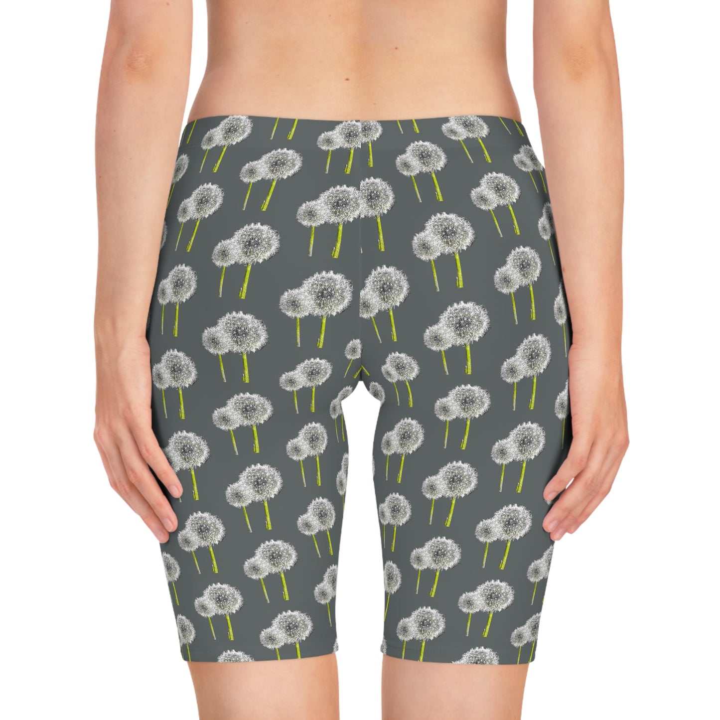 Back view of woman wearing Dandelion Women’s Bike Shorts with gray base and white dandelion print