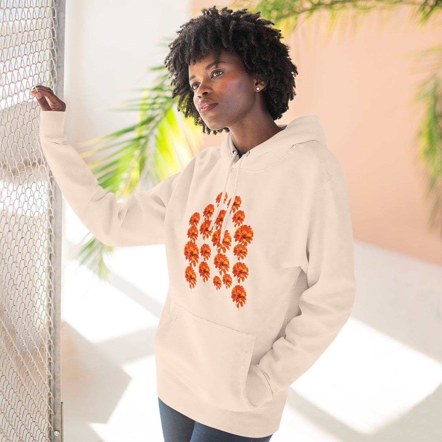Woman wearing cream Zinnia Hoodie posing indoors
