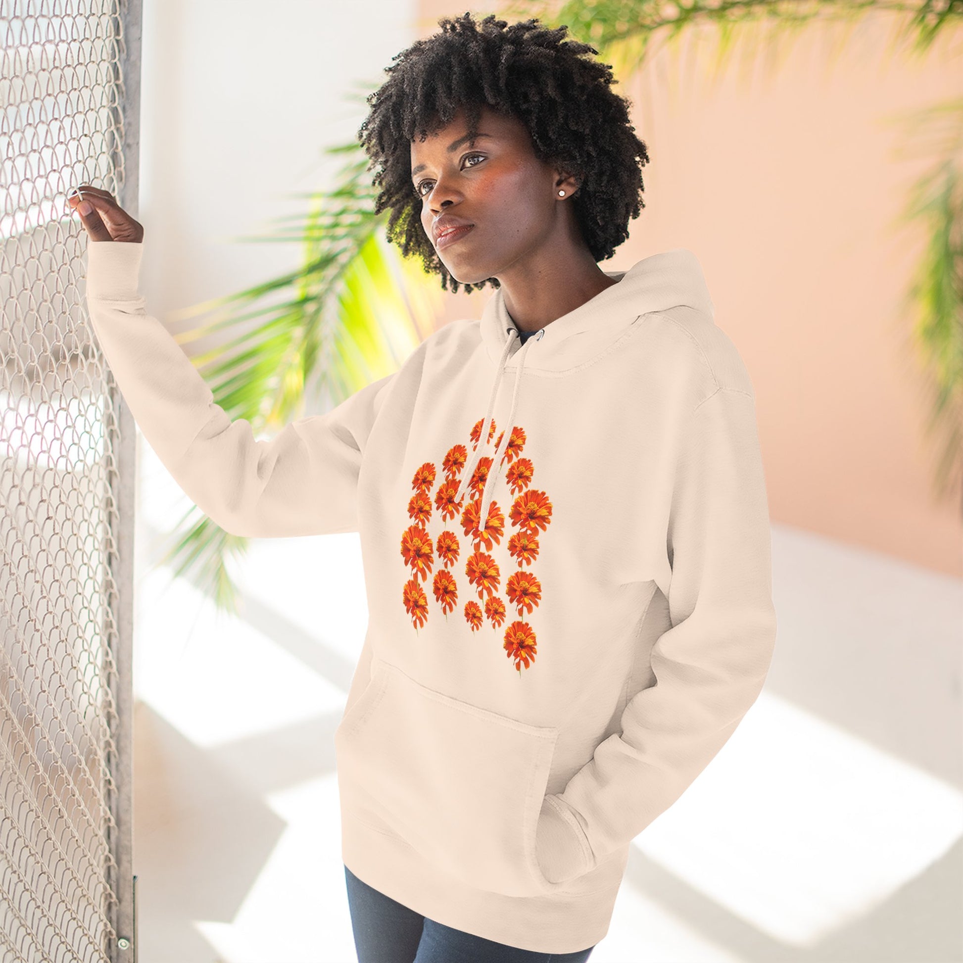 Woman wearing cream Zinnia Hoodie posing indoors
