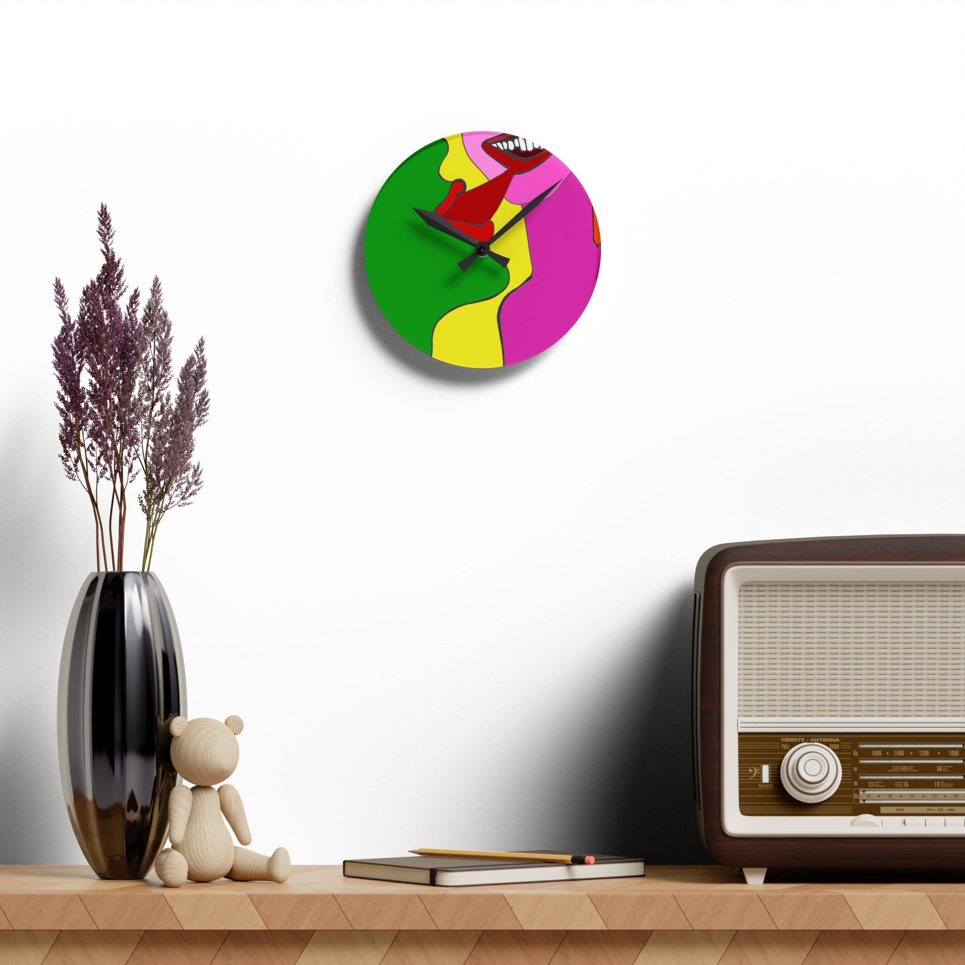 Colorful wall clock on a shelf with a vase, teddy bear, and vintage radio.