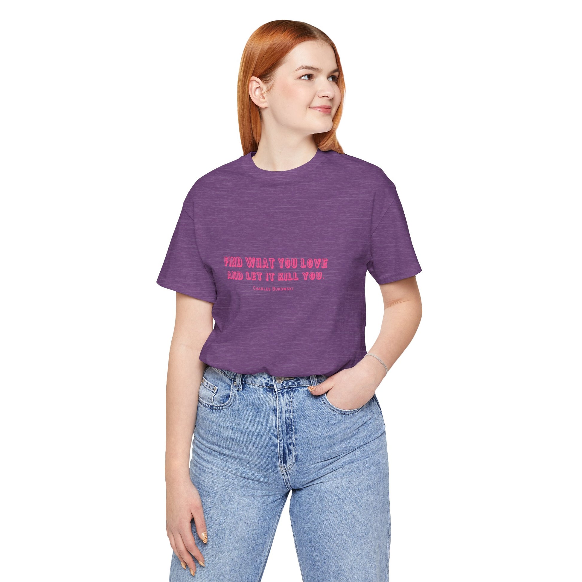 Woman wearing a purple Bukowski quote t-shirt with tucked-in jeans.