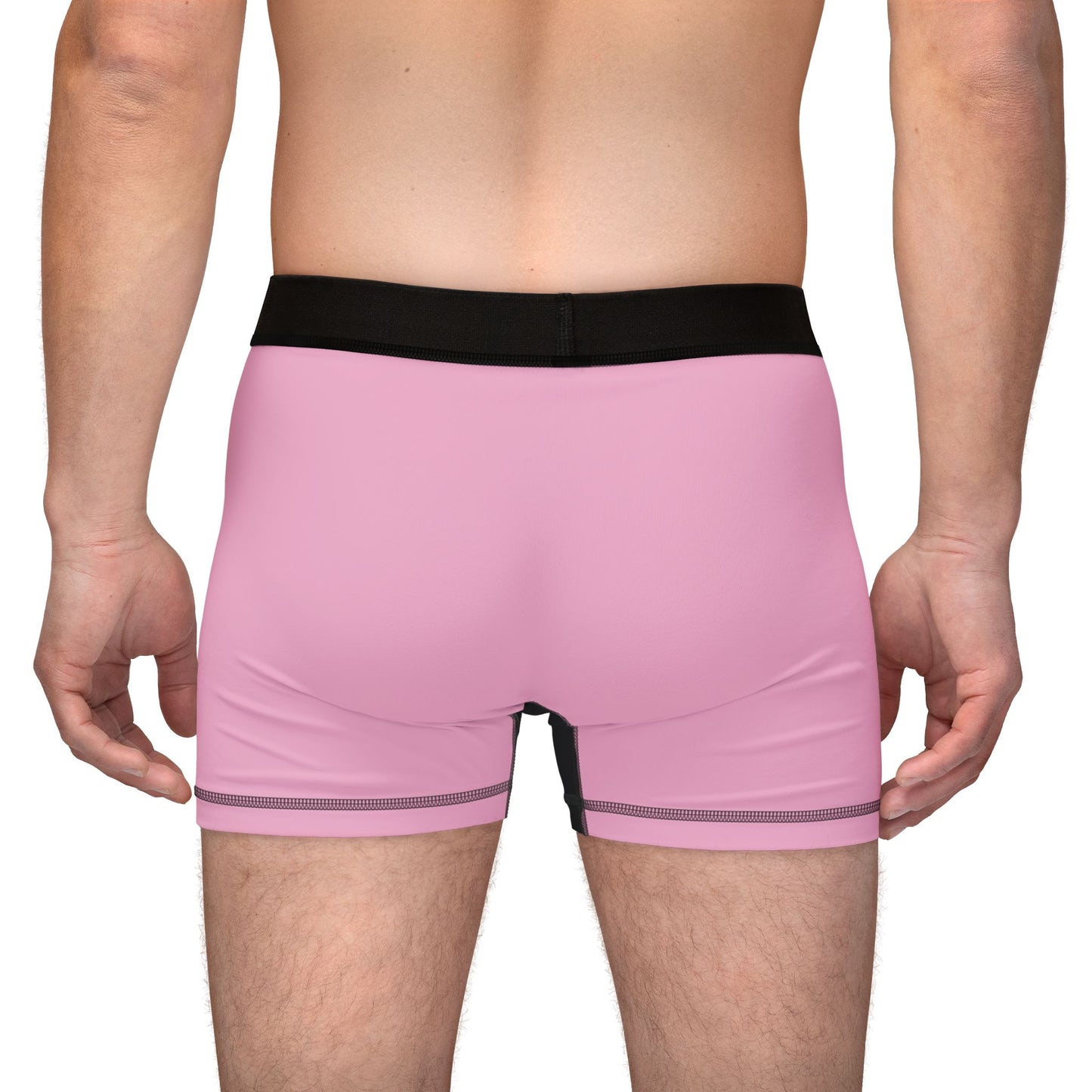 Back view of male model wearing boxer briefs showing solid pink back and black waistband.
