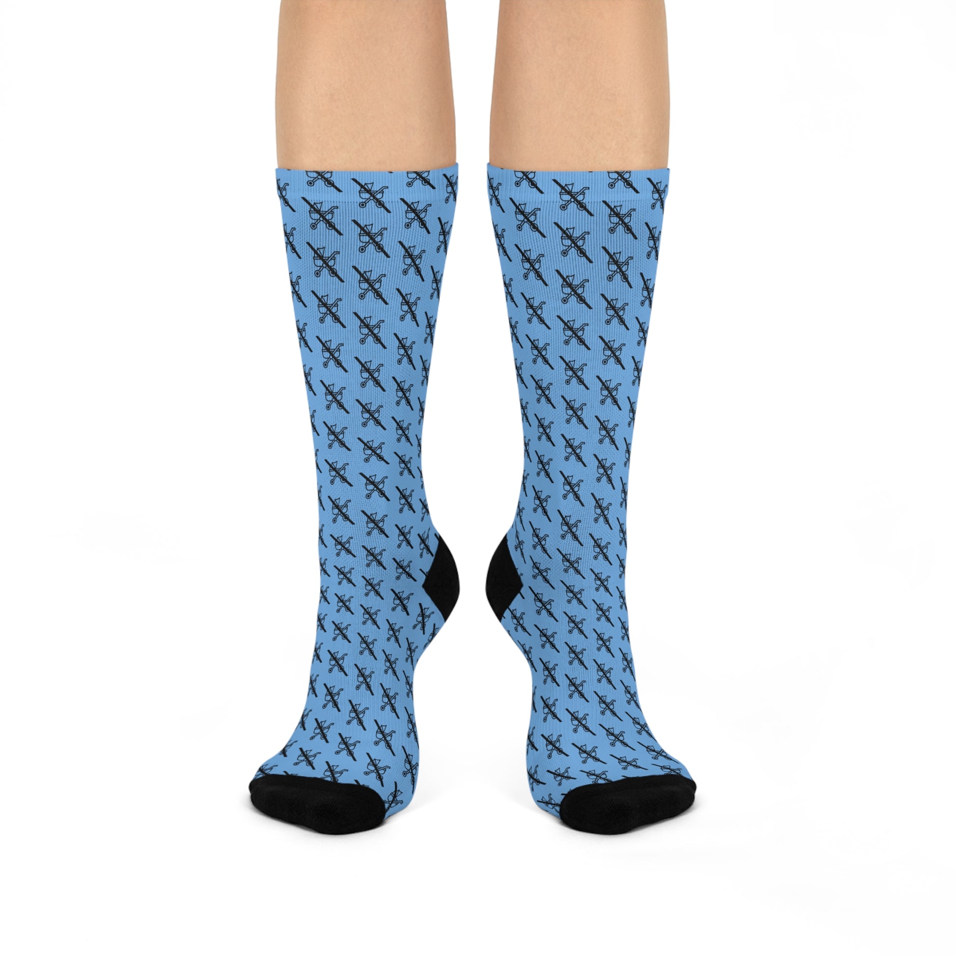 Pair of blue Proudly Childless crew socks with black accents shown on legs standing straight