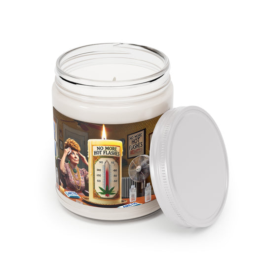 A novelty candle in a clear jar featuring vintage-style artwork of a woman experiencing hot flashes, surrounded by fans and ice, with a large candle illustration labeled “No More Hot Flashes” and a temperature gauge.
