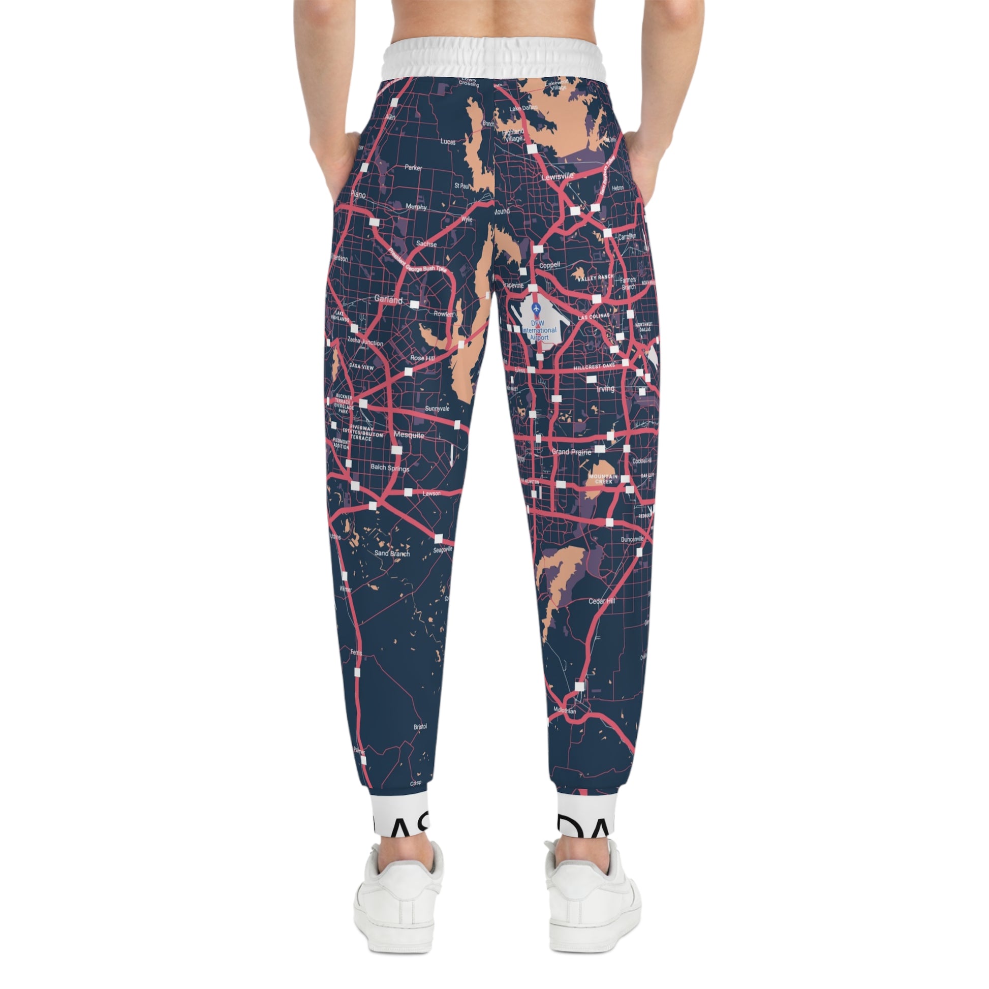 Map-patterned jogger pants worn by a person on a white background