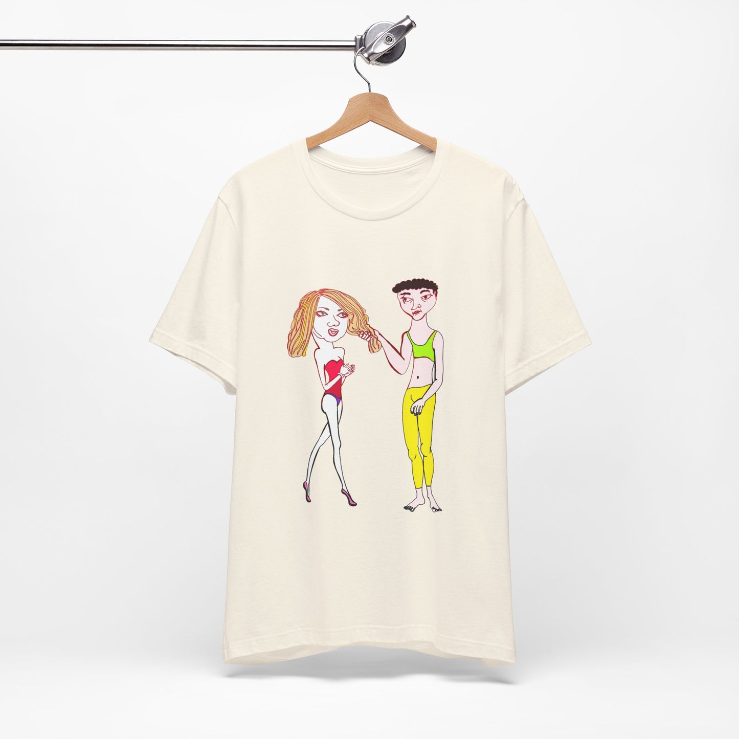 Cream Charlotte and Van hand-drawn couple tee hanging on a wooden hanger against a white wall.