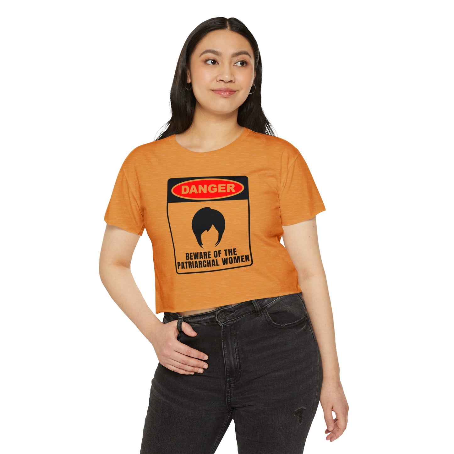 Model wearing the orange crop top with “Beware of the Patriarchal Women” text, casual streetwear outfit