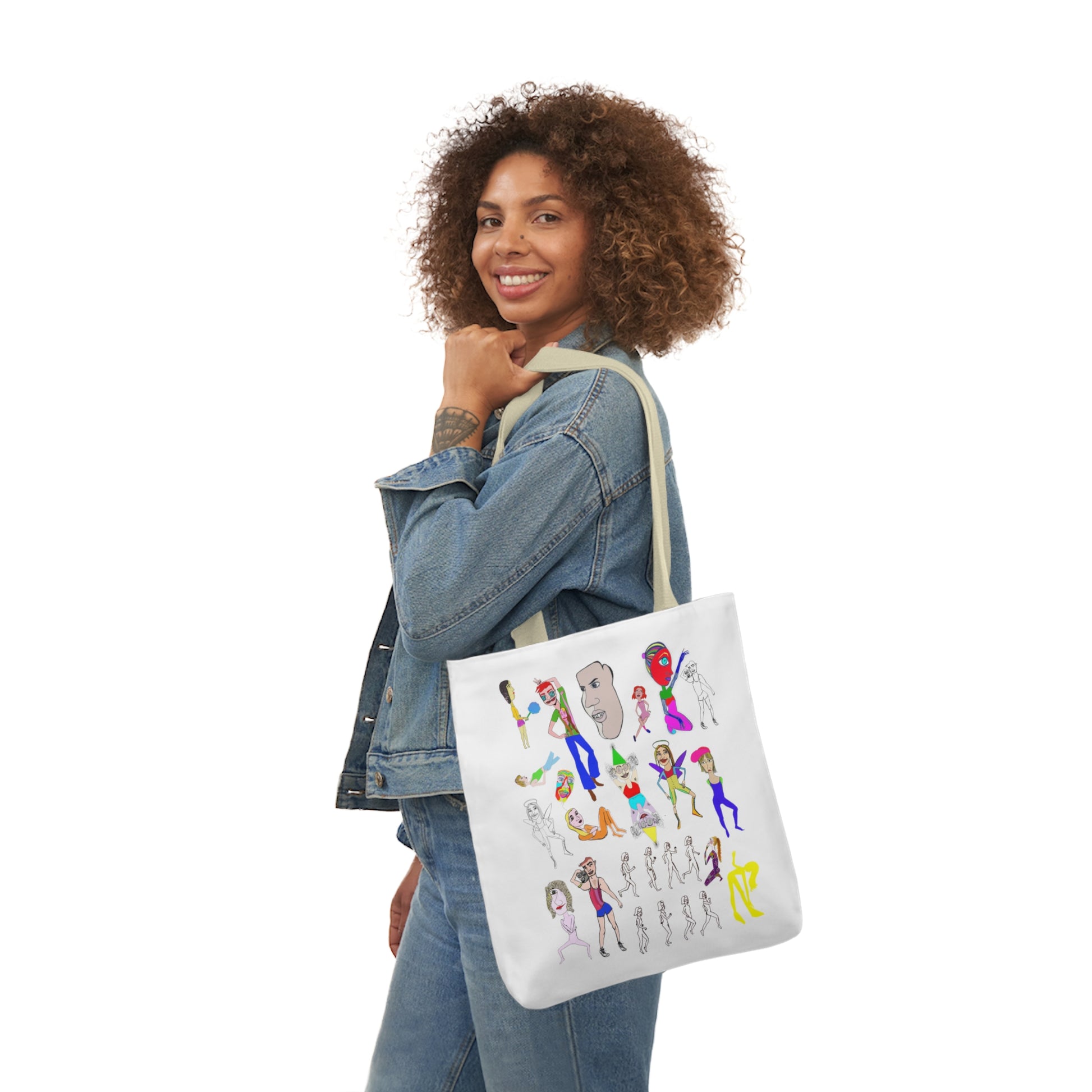 Woman carrying a a white tote bag featuring colorful cartoon-style characters and abstract figures