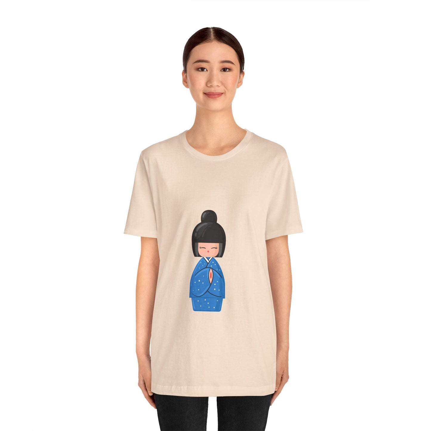 Woman in beige Geisha Blue T-Shirt styled with jeans