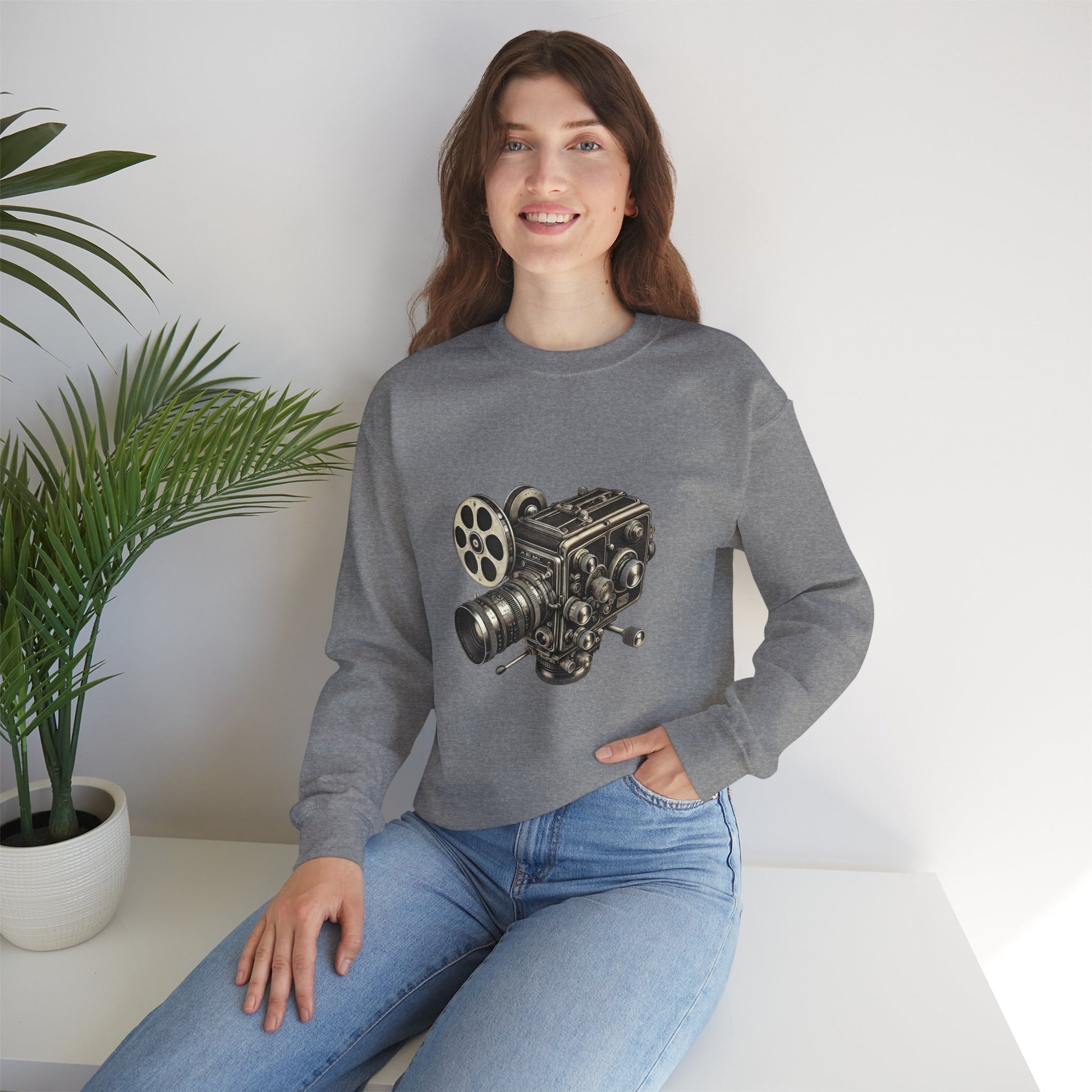 Woman seated, wearing gray Film Camera Sweatshirt, styled casually with jeans.