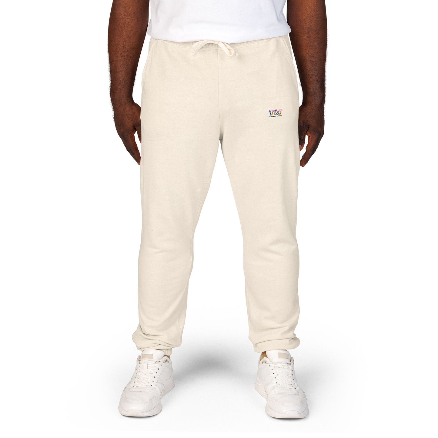 Person wearing cream jogger pants with Tantrum Media logo on a white background